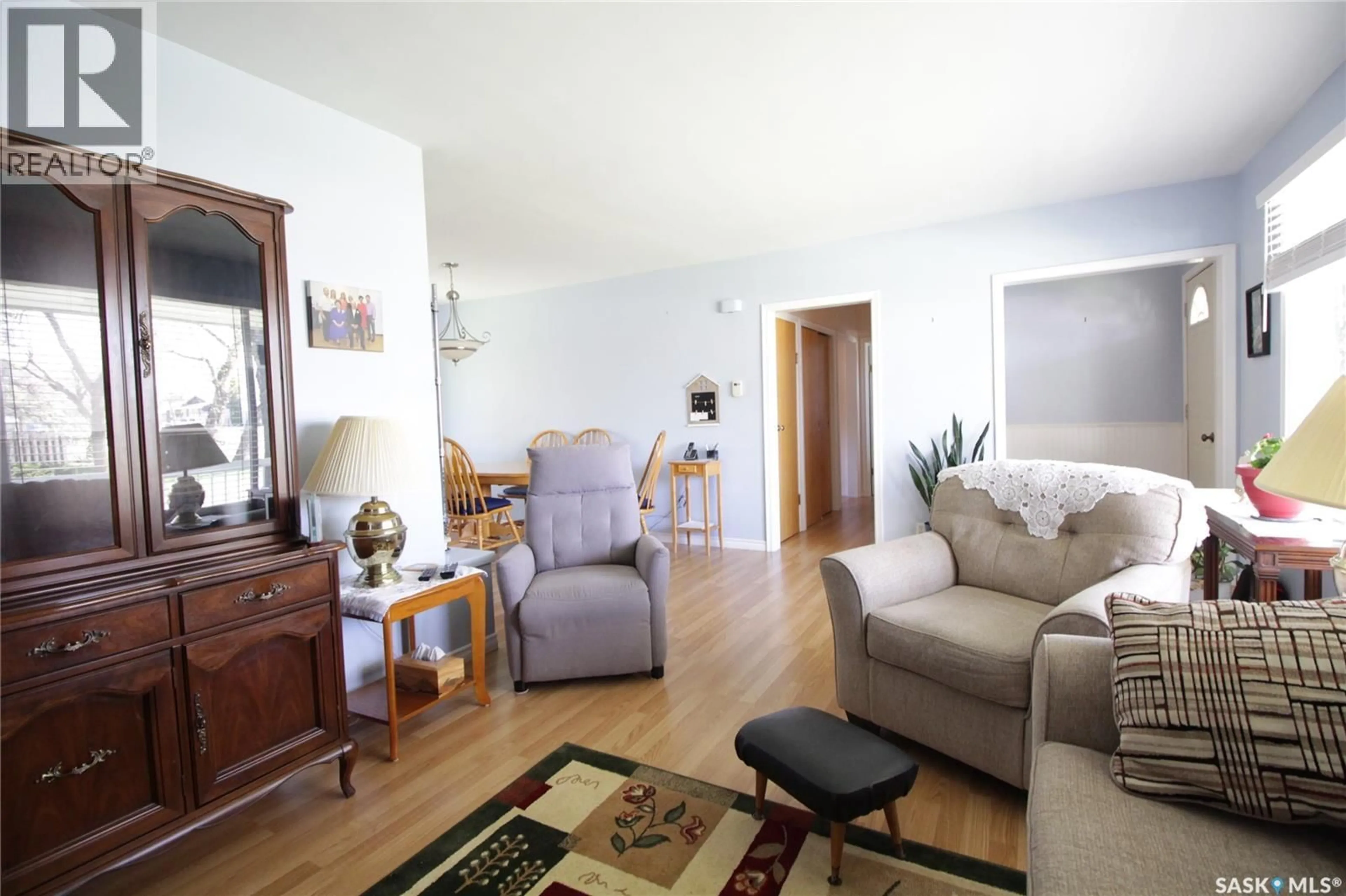 Living room with furniture, wood/laminate floor for 1208 MARK AVENUE, Moosomin Saskatchewan S0G3N0