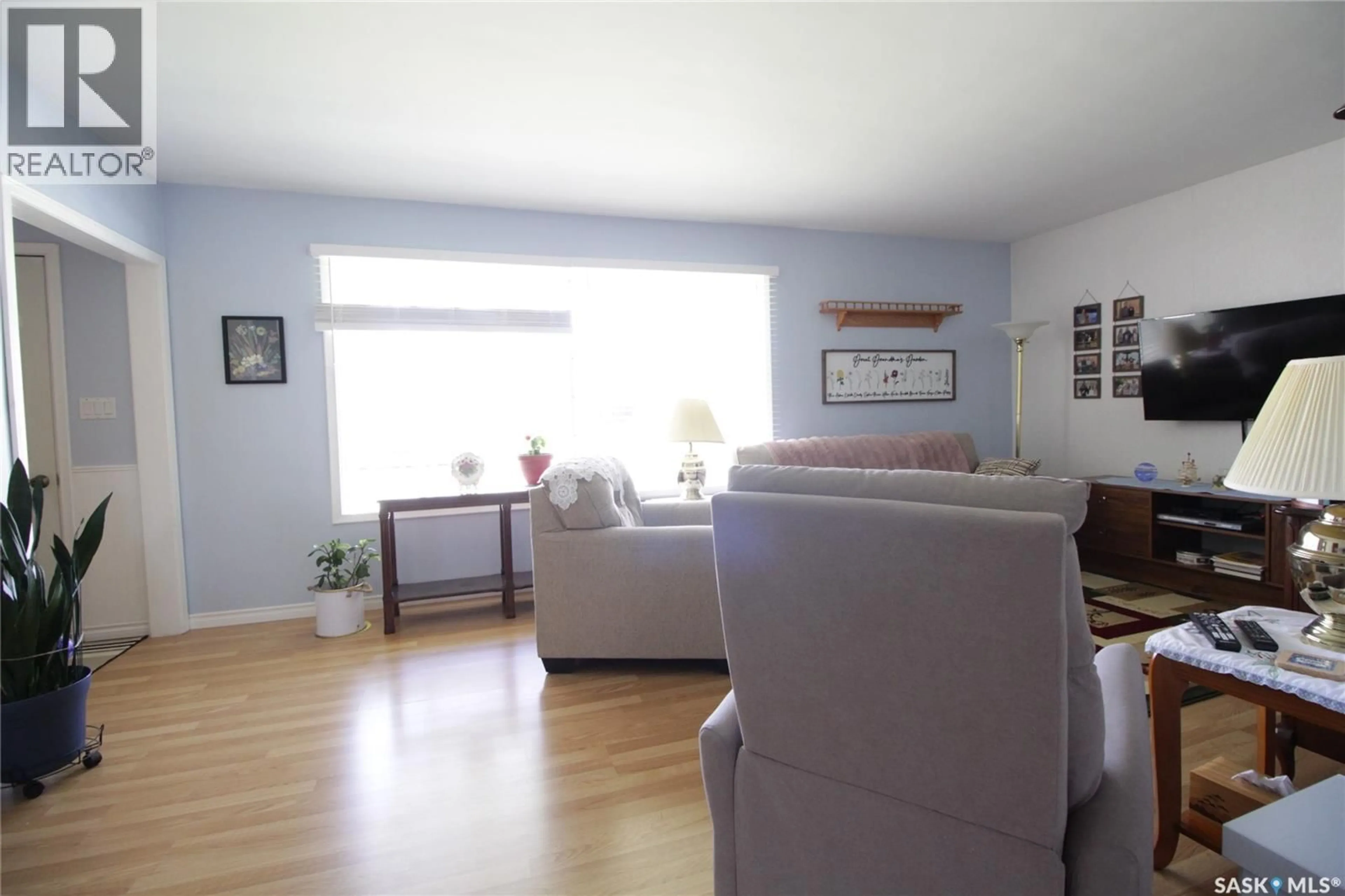 Living room with furniture, wood/laminate floor for 1208 MARK AVENUE, Moosomin Saskatchewan S0G3N0