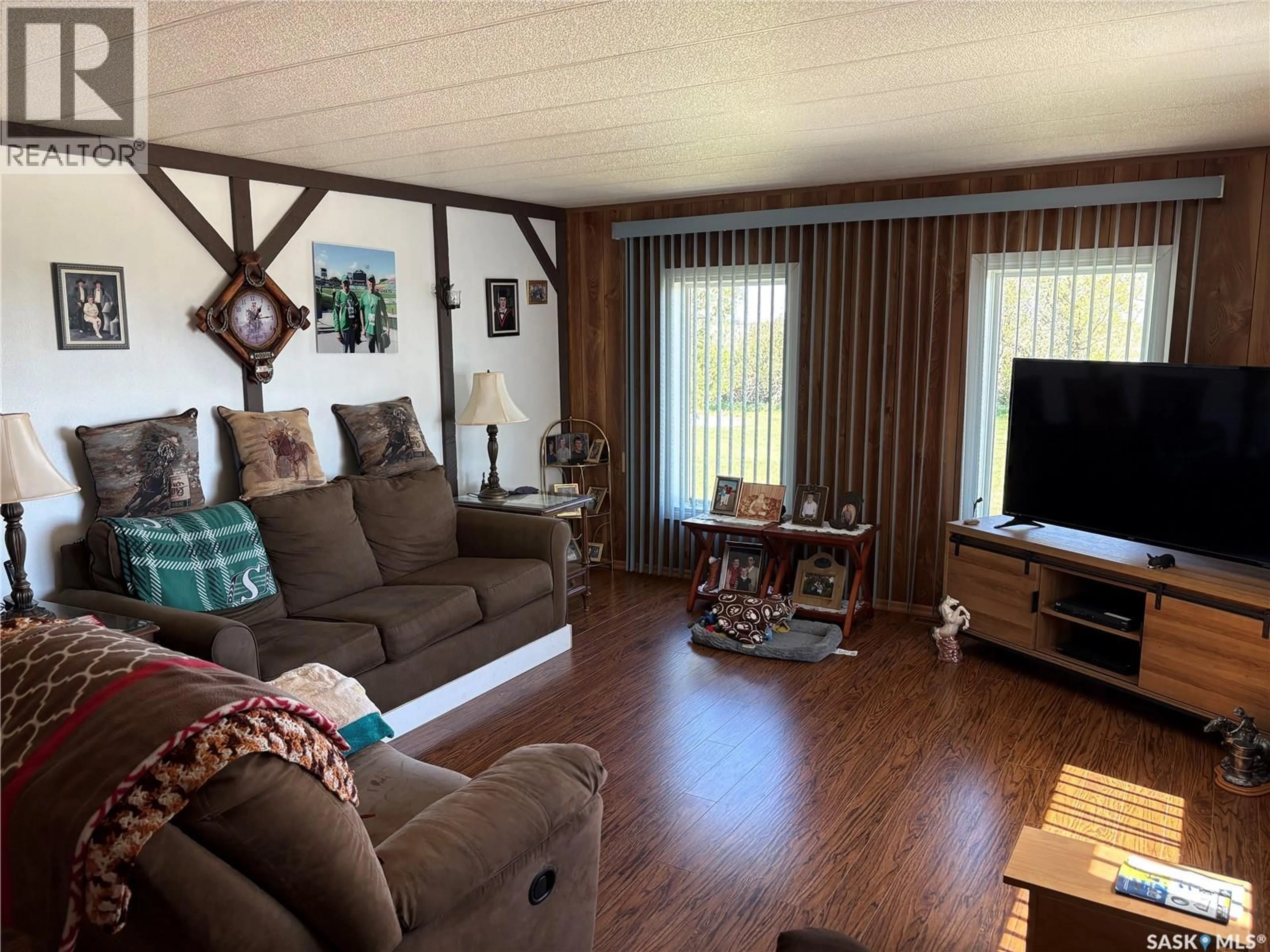 Living room with furniture, wood/laminate floor for LAROSE ACREAGE, Mctaggart Saskatchewan S4H2K3