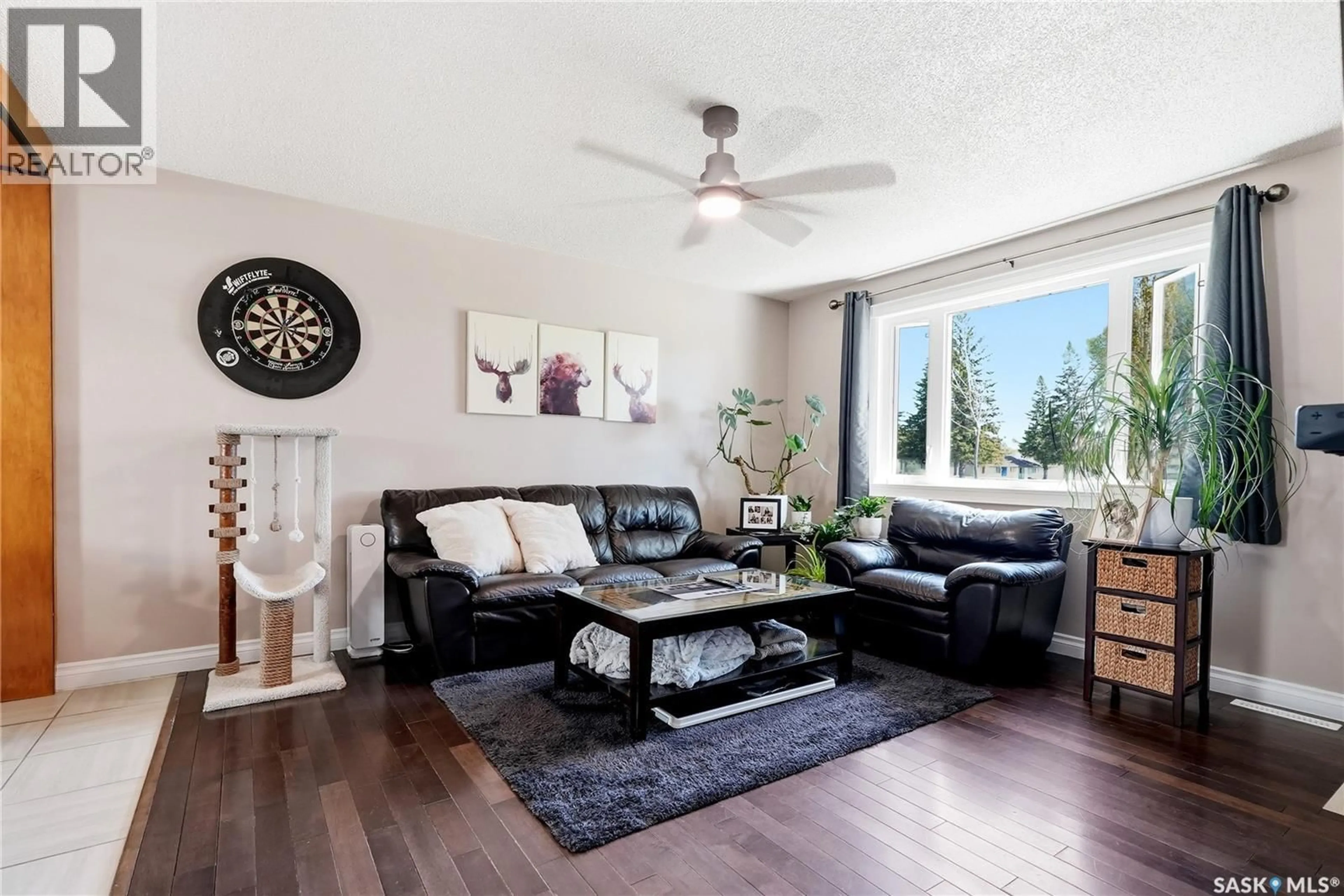 Living room with furniture, wood/laminate floor for 901 R AVENUE N, Saskatoon Saskatchewan S7L2Z4