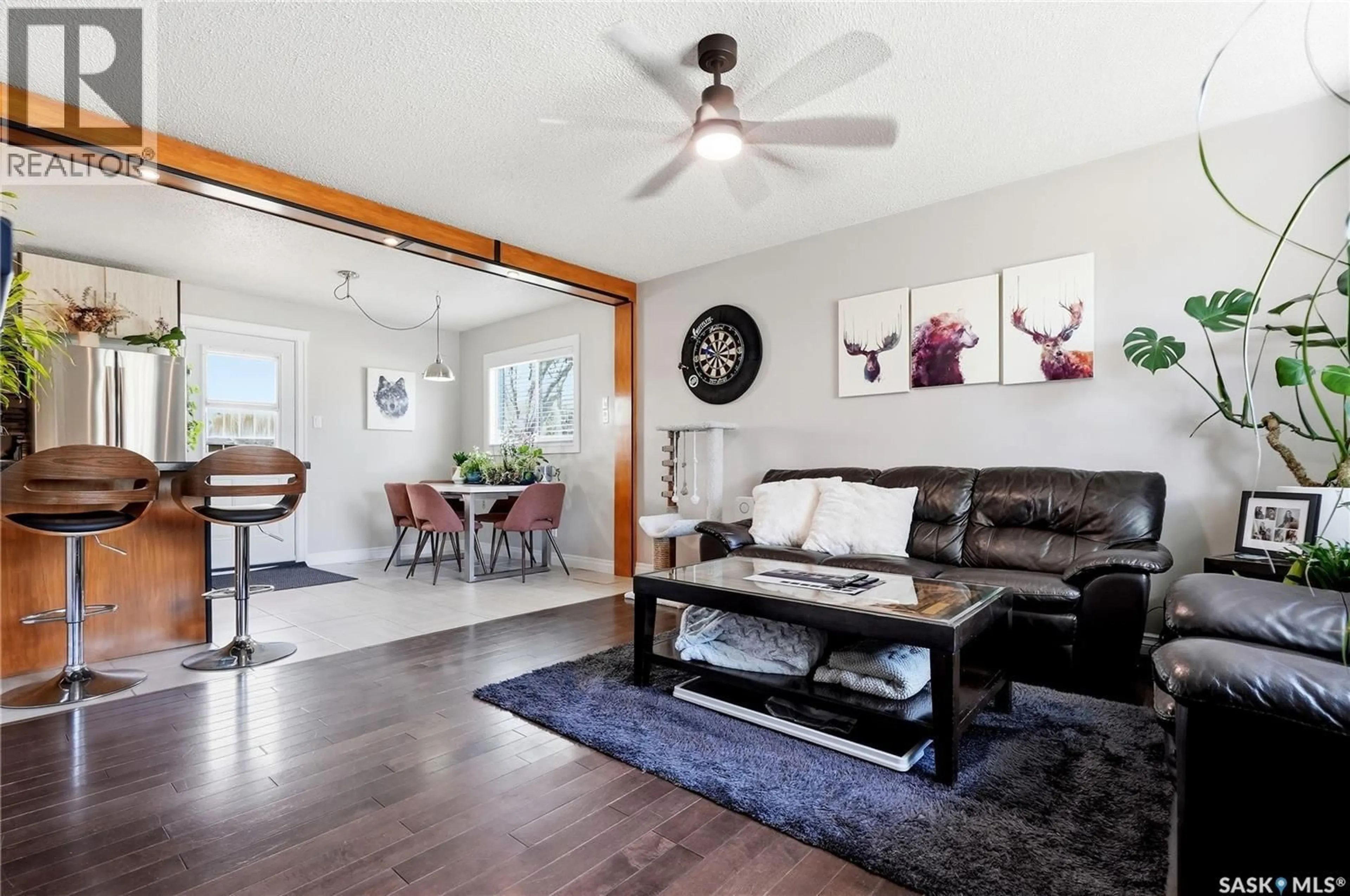 Living room with furniture, wood/laminate floor for 901 R AVENUE N, Saskatoon Saskatchewan S7L2Z4