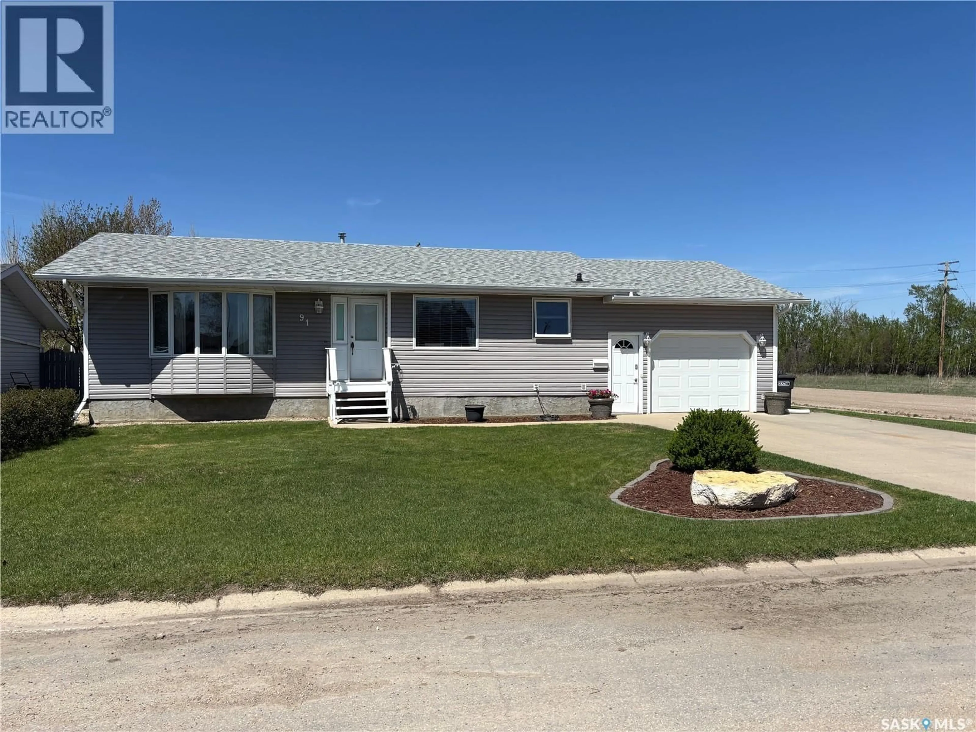 Home with vinyl exterior material, street for 91 2ND AVENUE, Humboldt Saskatchewan S0K2A0