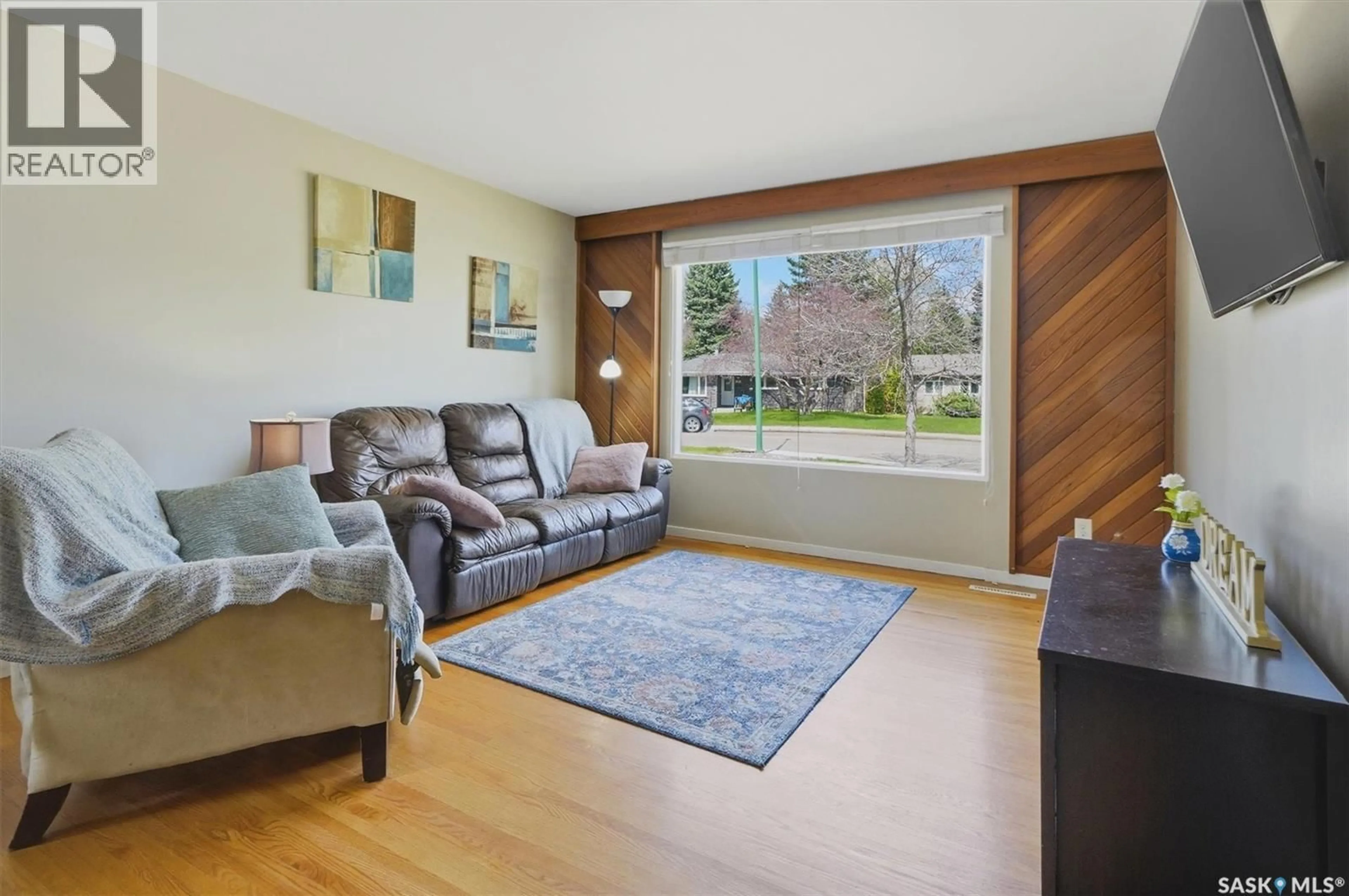 Living room with furniture, wood/laminate floor for 12 MURPHY CRESCENT, Saskatoon Saskatchewan S7J2T4