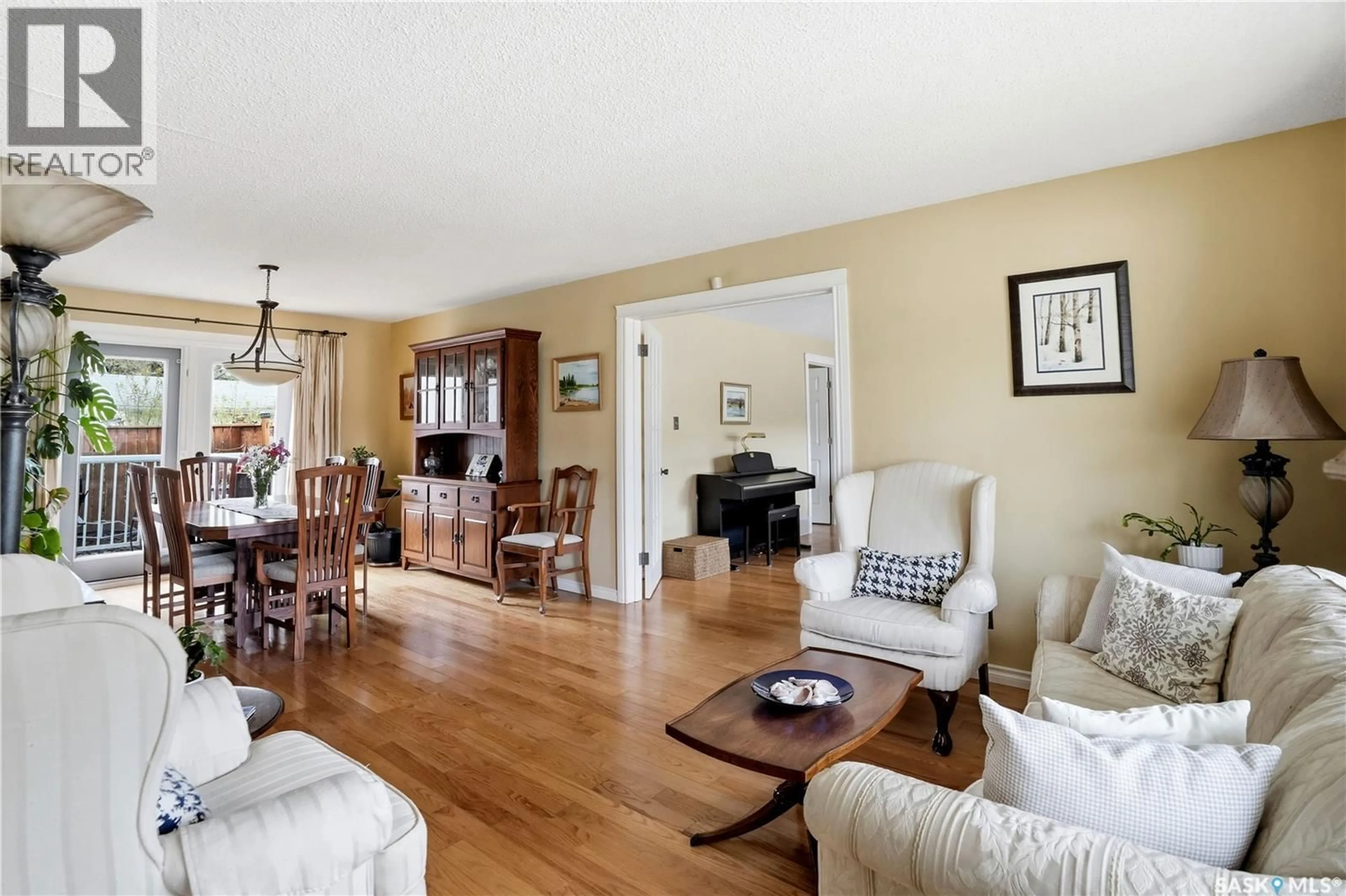 Living room with furniture, wood/laminate floor for 1456 SHANNON ROAD, Regina Saskatchewan S4S5L5
