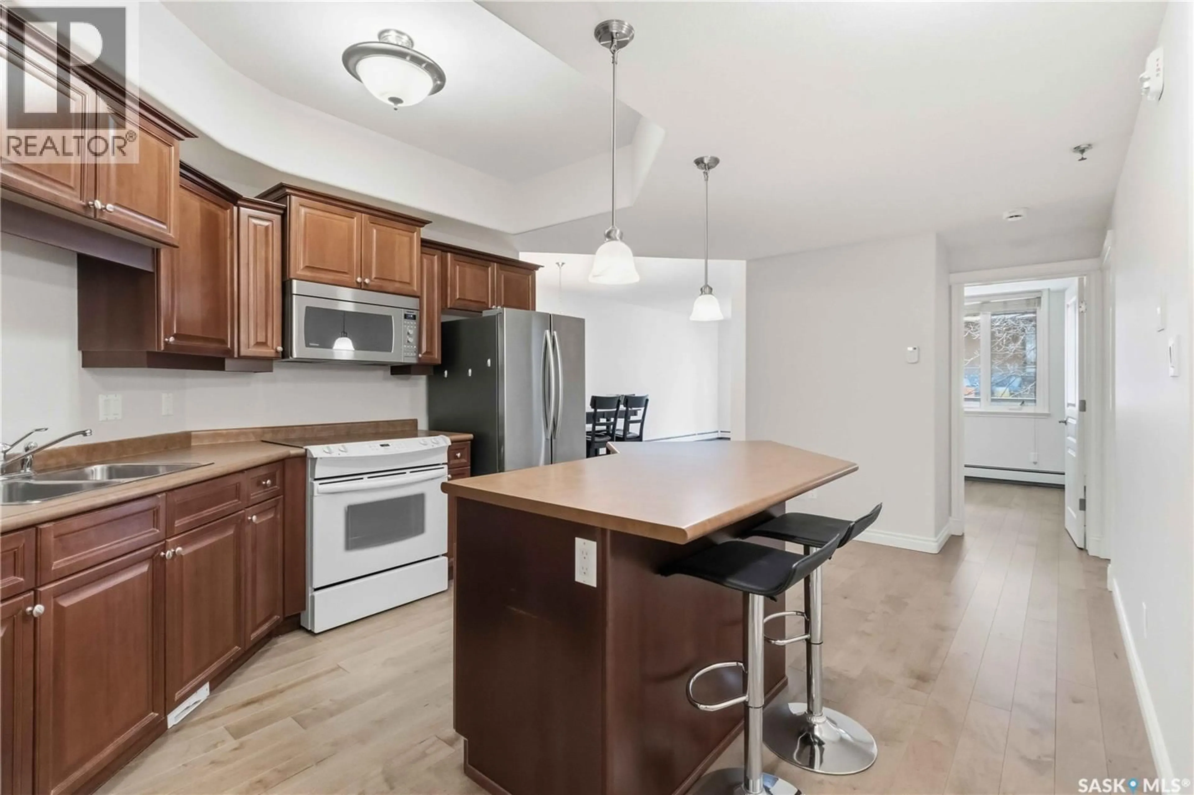 Open concept kitchen, wood/laminate floor for 112 619 SASKATCHEWAN CRESCENT, Saskatoon Saskatchewan S7M0A5