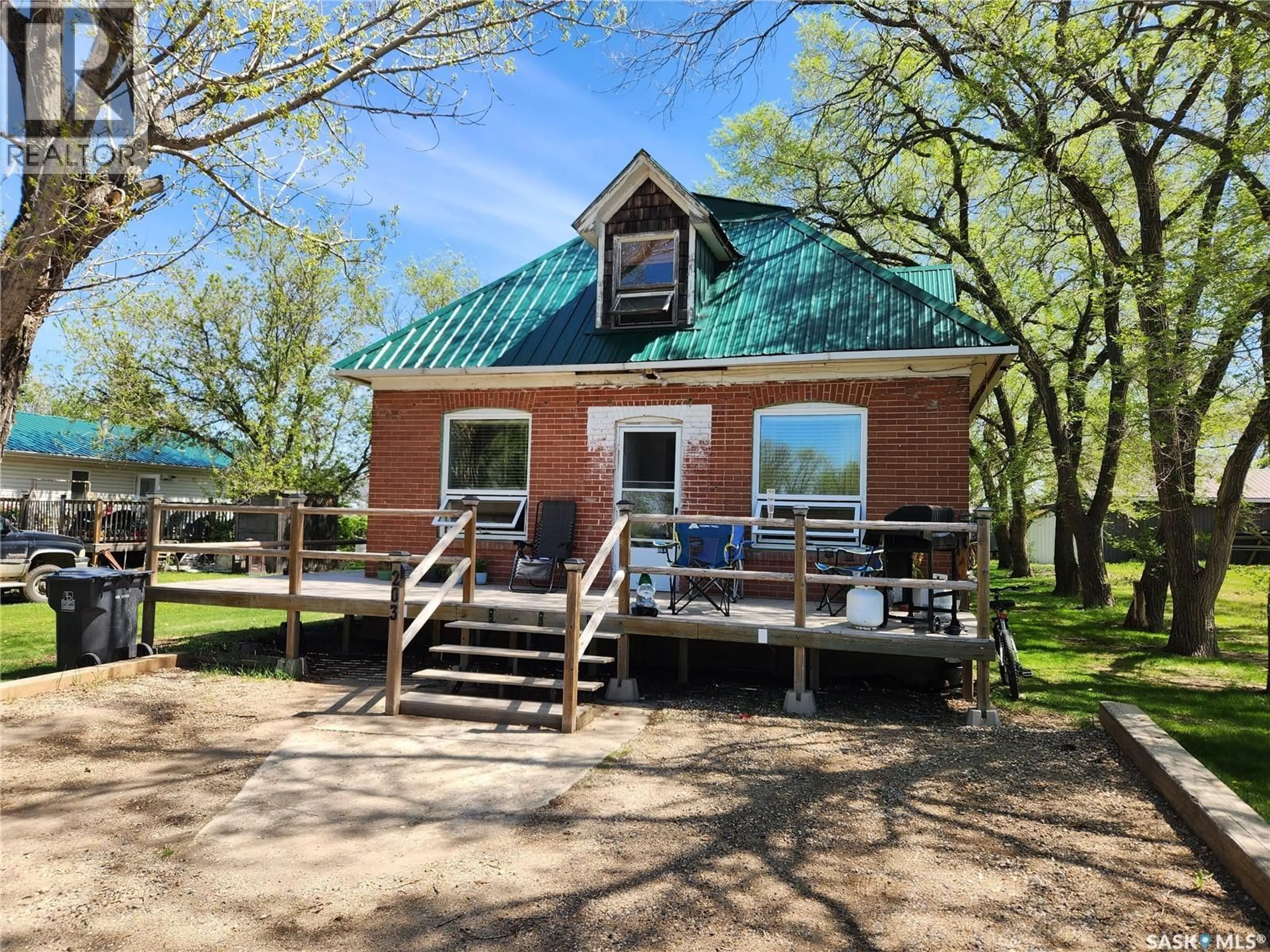 A pic from outside/outdoor area/front of a property/back of a property/a pic from drone, water/lake/river/ocean view for 203 BELFAST STREET, North Portal Saskatchewan S0C1W0
