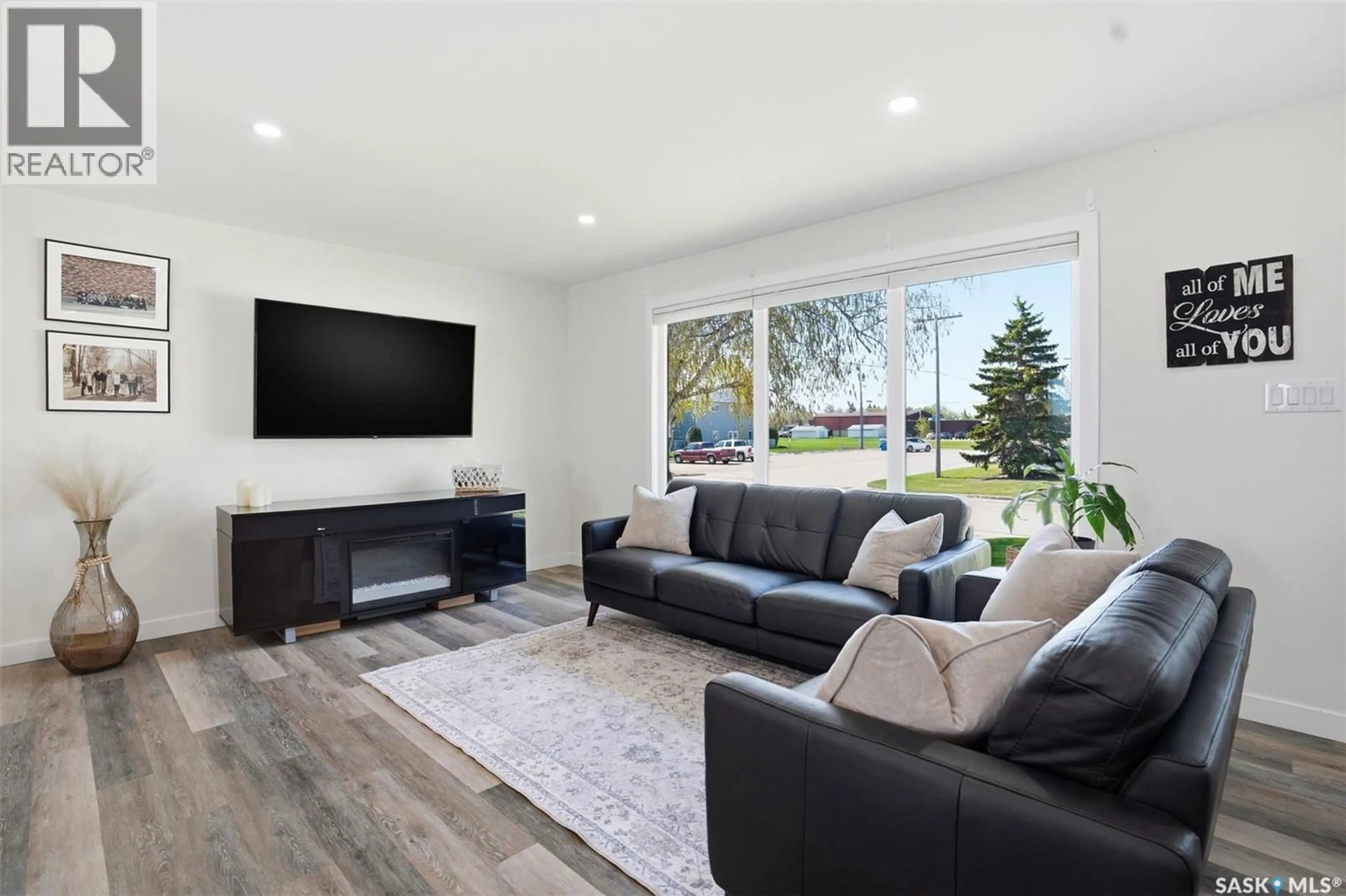 Living room with furniture, wood/laminate floor for 112 8TH AVENUE, Watrous Saskatchewan S0K4T0