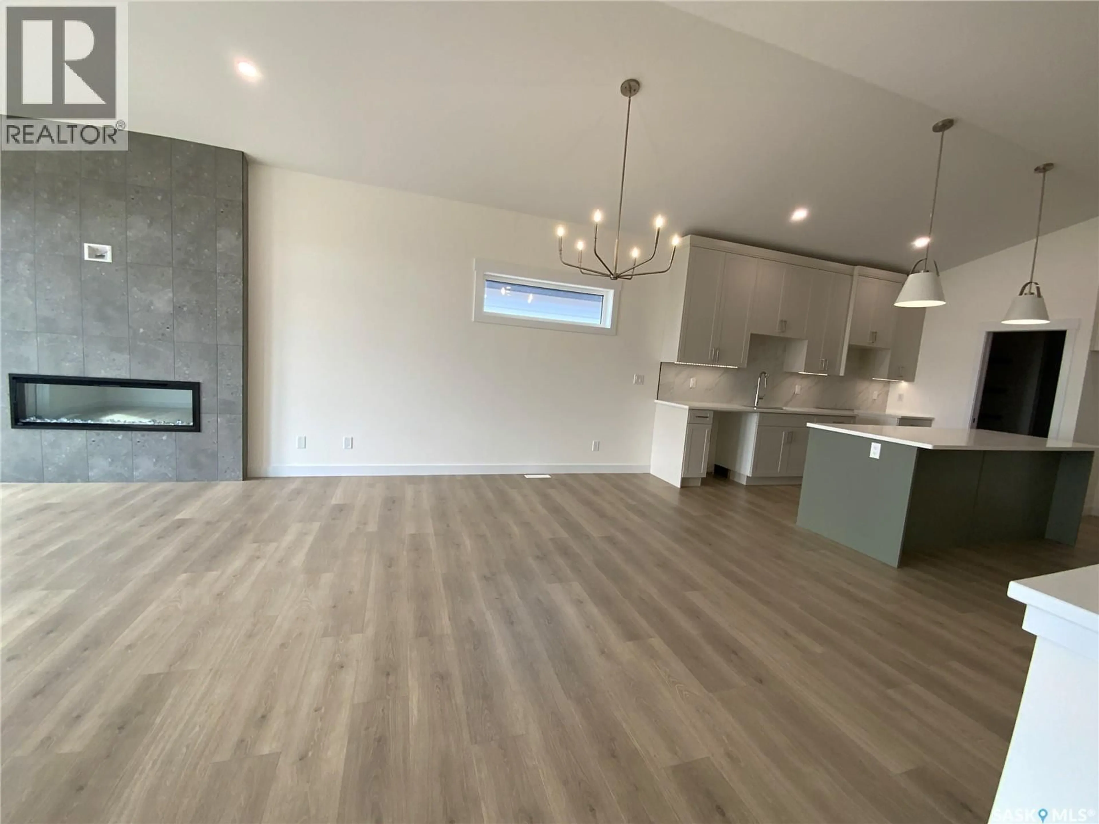 Open concept kitchen, wood/laminate floor for 242 DORAN WAY, Saskatoon Saskatchewan S7H4N2