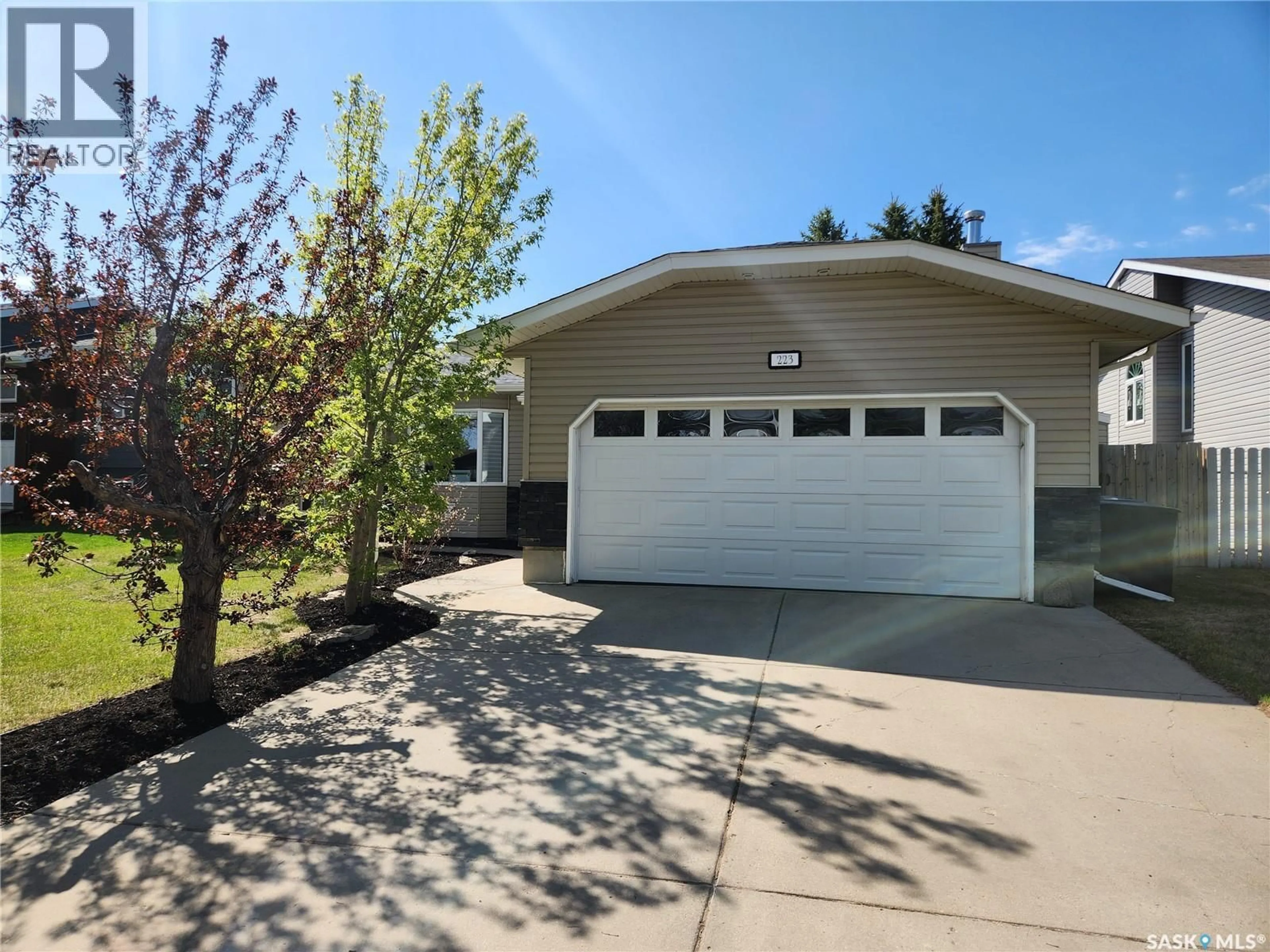 Home with vinyl exterior material, street for 223 ADILMAN DRIVE, Saskatoon Saskatchewan S7K7S1
