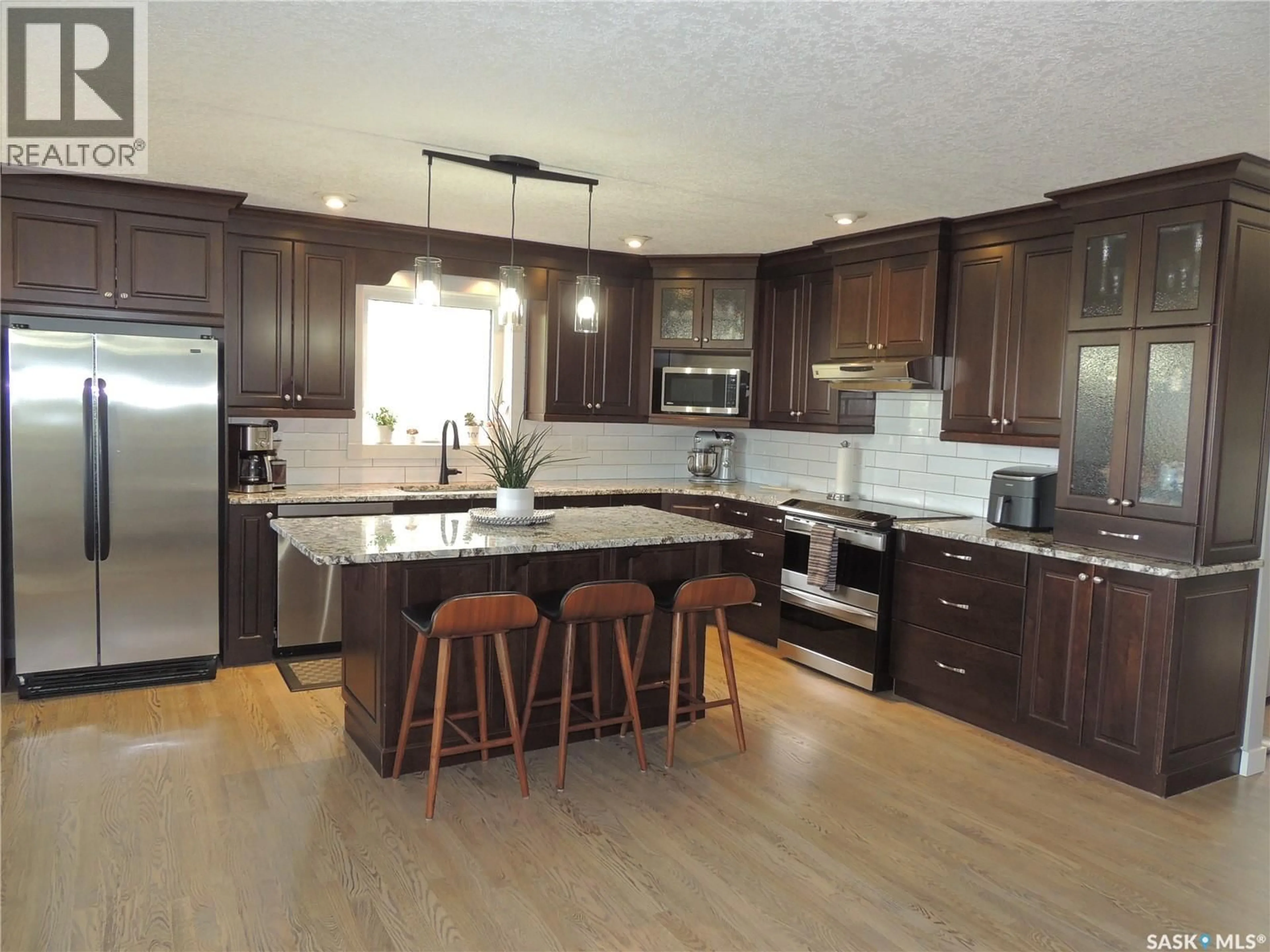Open concept kitchen, wood/laminate floor for YERGENS ACREAGE, Estevan Rm No. 5 Saskatchewan S4A2A7