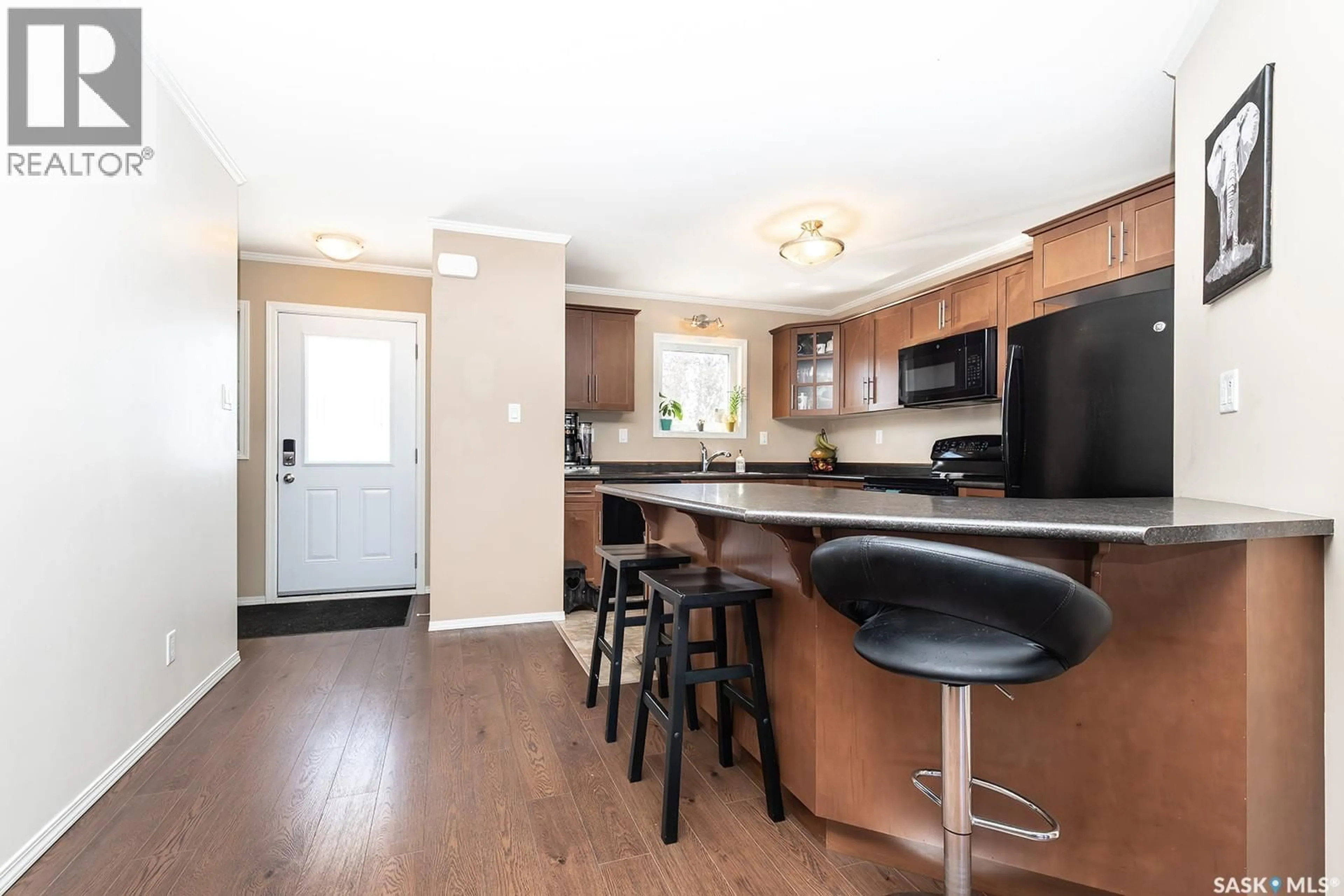 Open concept kitchen, wood/laminate floor for 104 225 HASSARD CLOSE, Saskatoon Saskatchewan S7L2W8