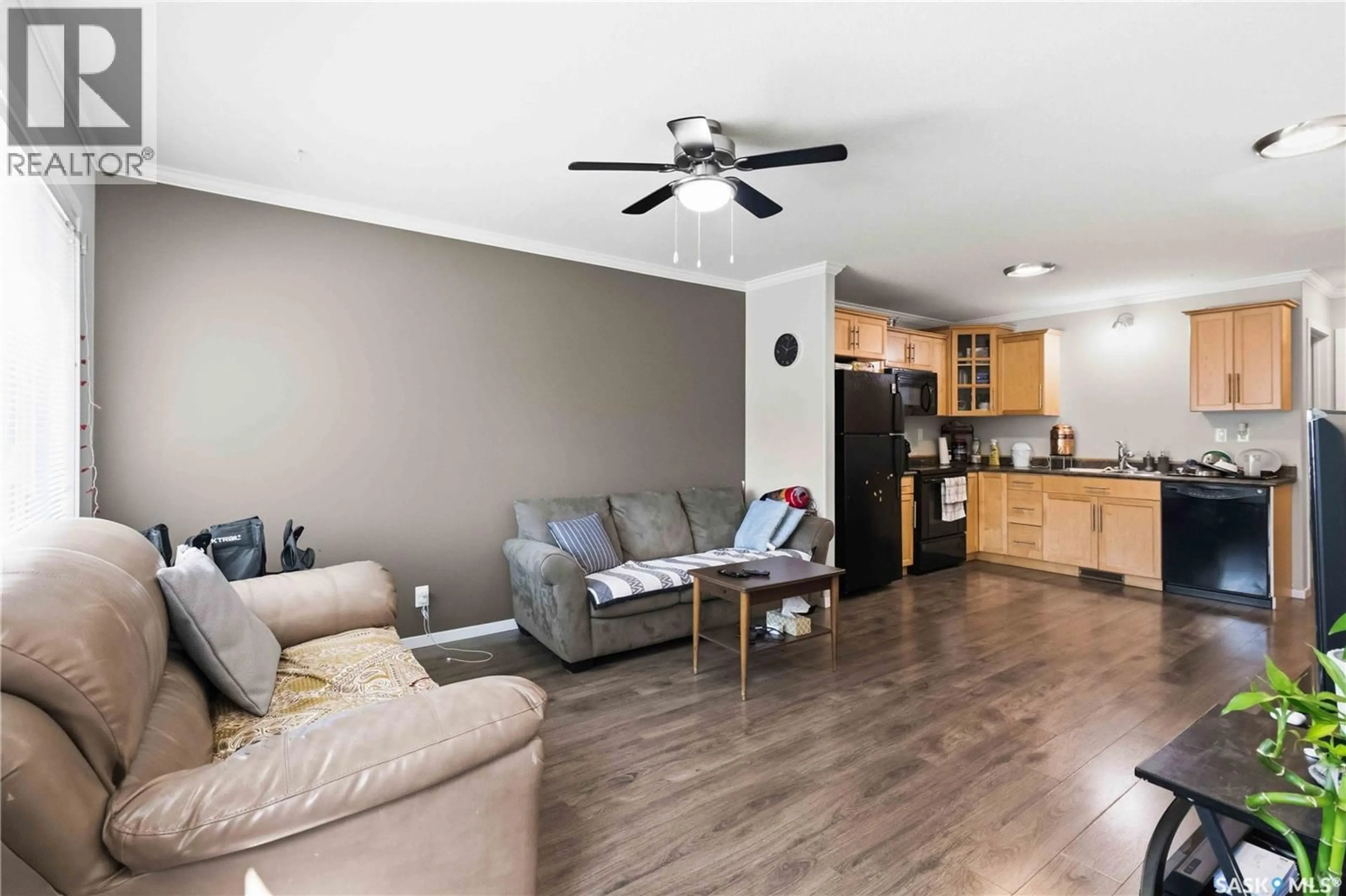 Living room with furniture, wood/laminate floor for 110 - 803 SHILLINGTON CRESCENT, Saskatoon Saskatchewan S7M3Z8