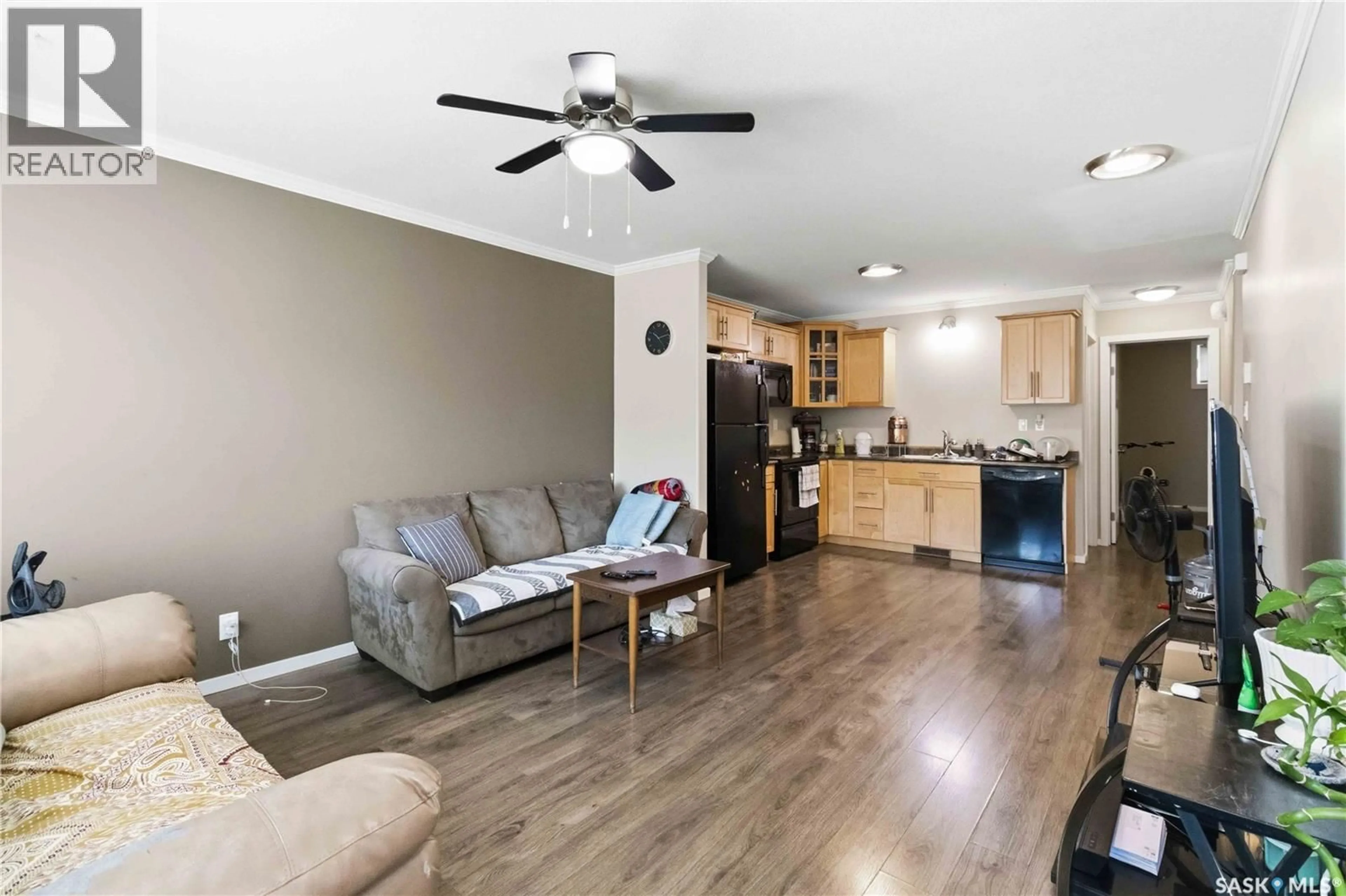 Living room with furniture, wood/laminate floor for 110 - 803 SHILLINGTON CRESCENT, Saskatoon Saskatchewan S7M3Z8