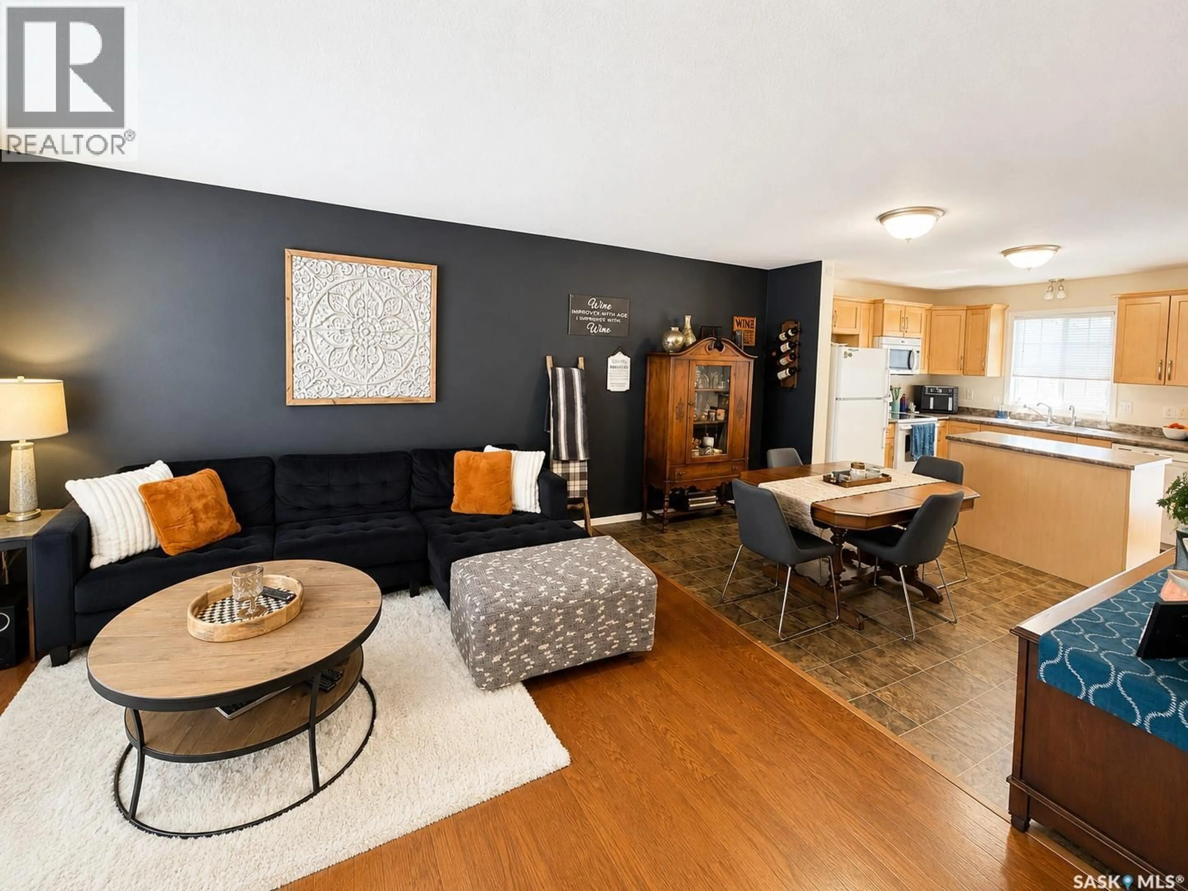 Living room with furniture, wood/laminate floor for 107 - 4801 CHILD AVENUE, Regina Saskatchewan S4X0C4