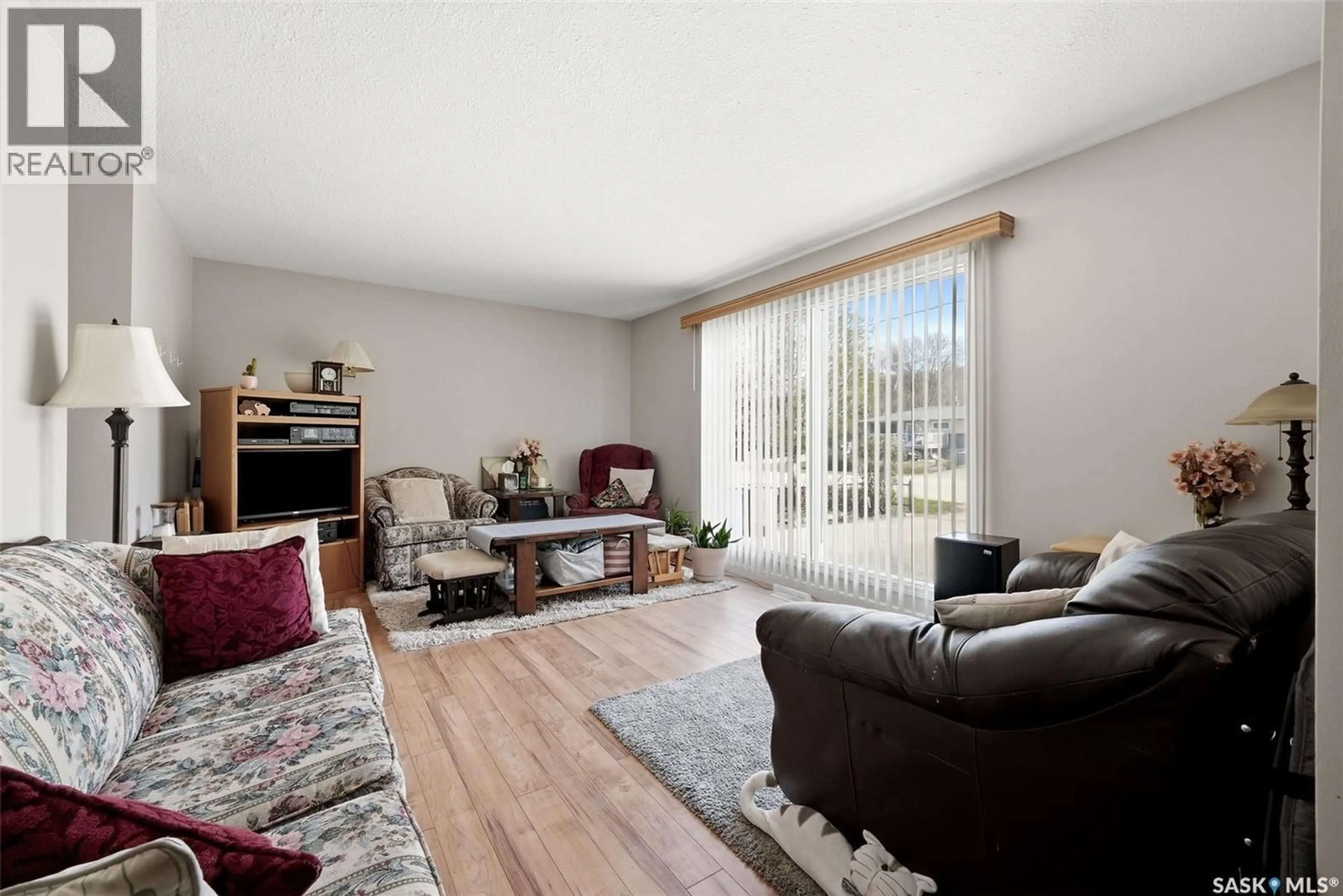 Living room with furniture, wood/laminate floor for 220 QU'APPELLE DRIVE, Lumsden Saskatchewan S0G3C0