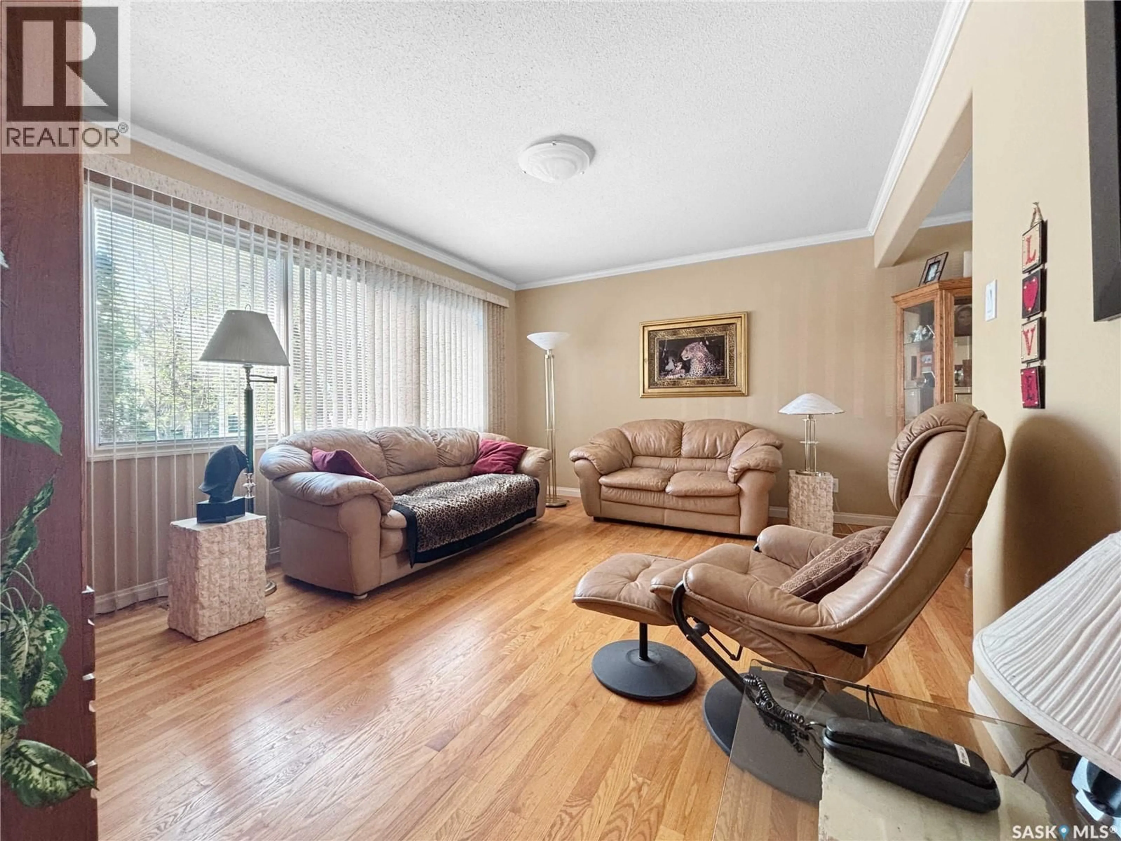 Living room with furniture, wood/laminate floor for 2140 37TH STREET, Saskatoon Saskatchewan S7L4E3