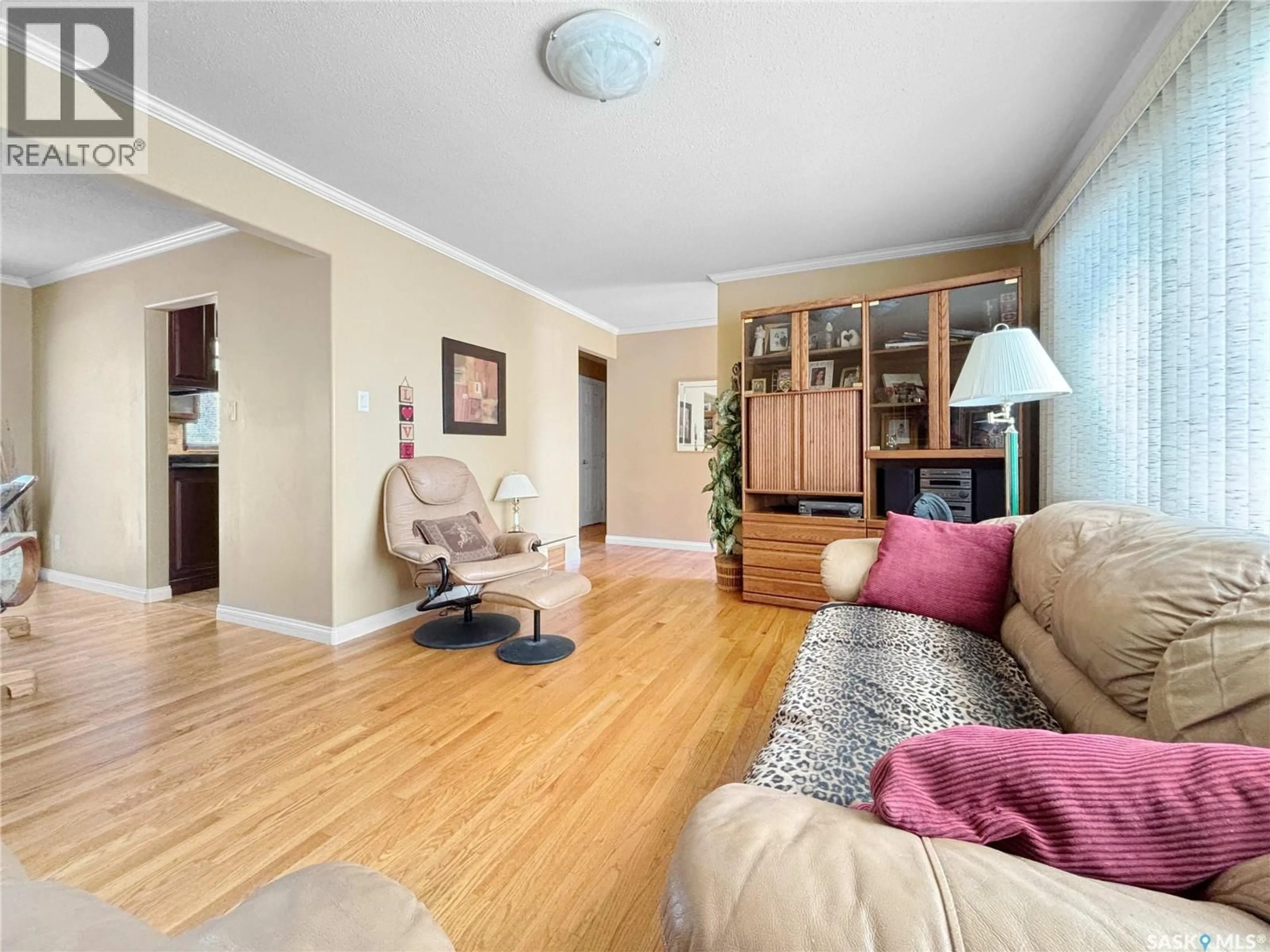 Living room with furniture, wood/laminate floor for 2140 37TH STREET, Saskatoon Saskatchewan S7L4E3