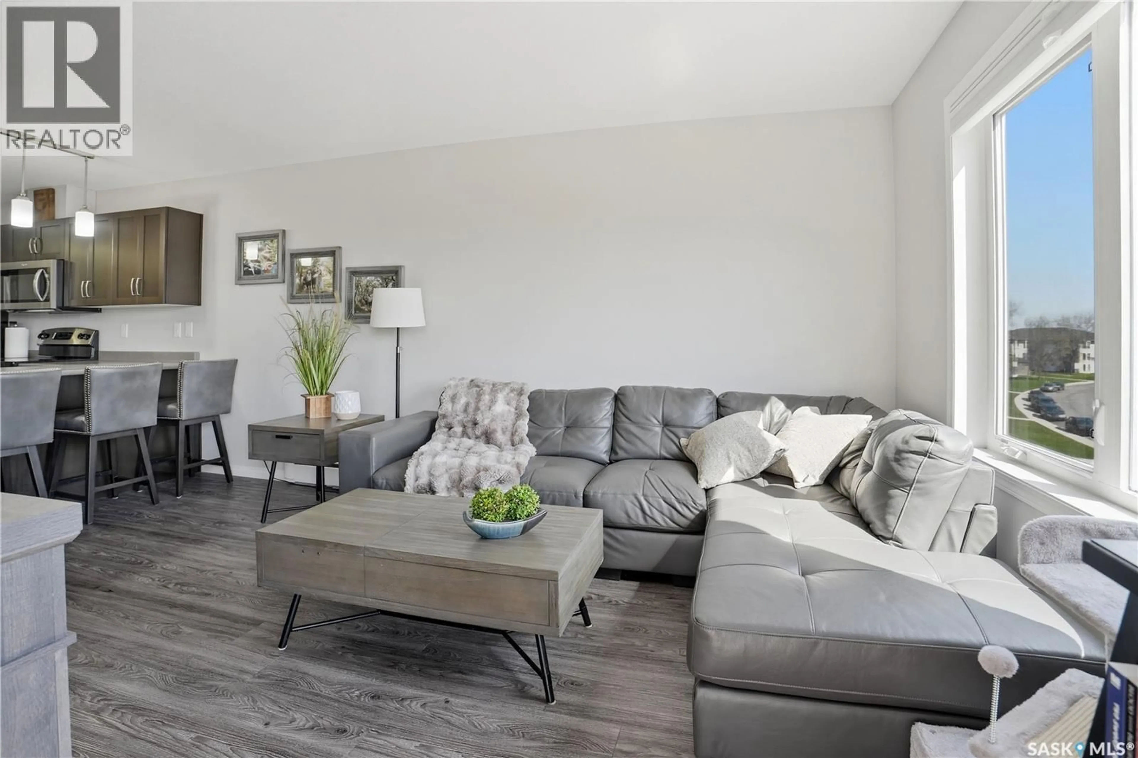 Living room with furniture, wood/laminate floor for 305 - 2452 KILLDEER DRIVE, North Battleford Saskatchewan S9A3T5