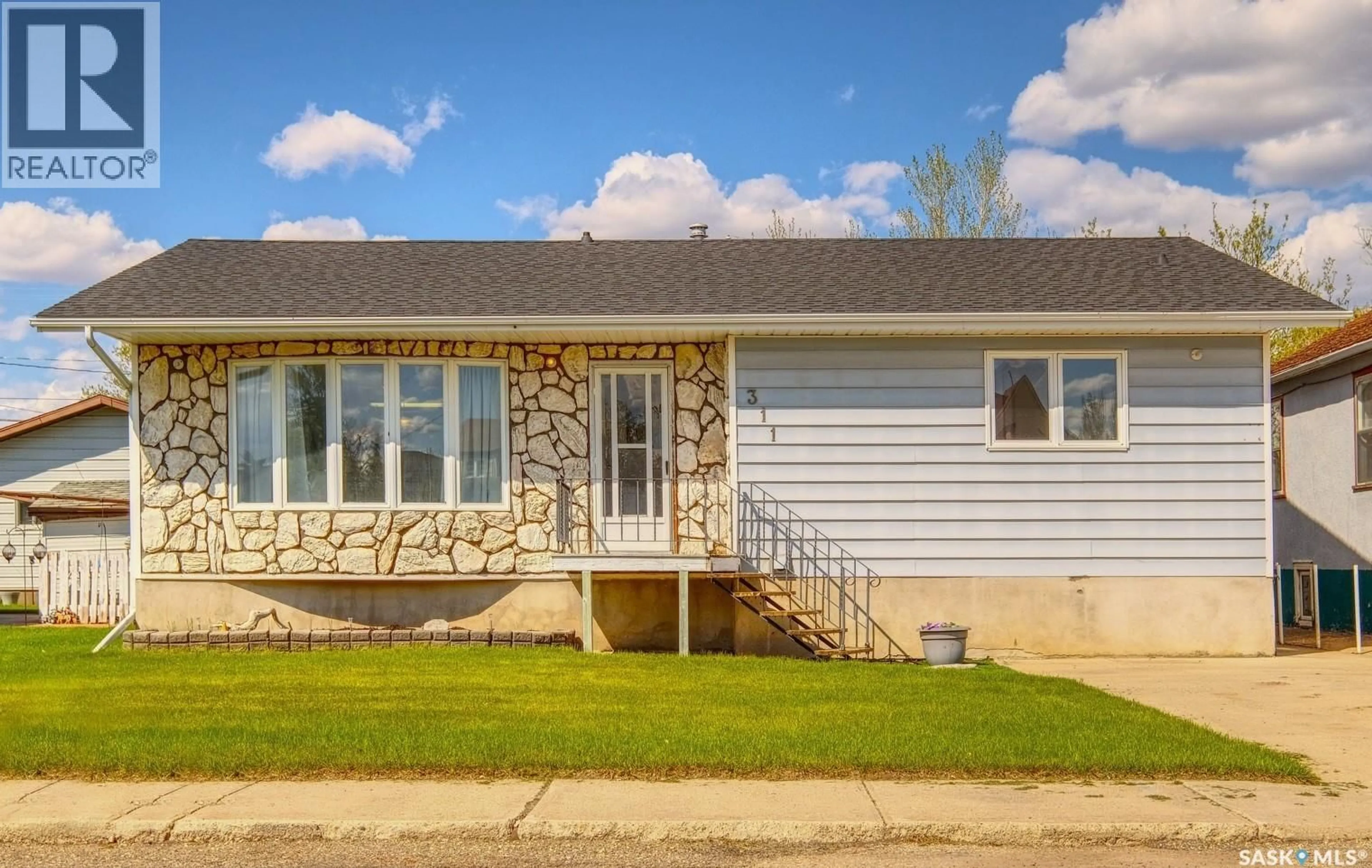Home with vinyl exterior material, street for 311 4TH AVENUE, Biggar Saskatchewan S0K0M0