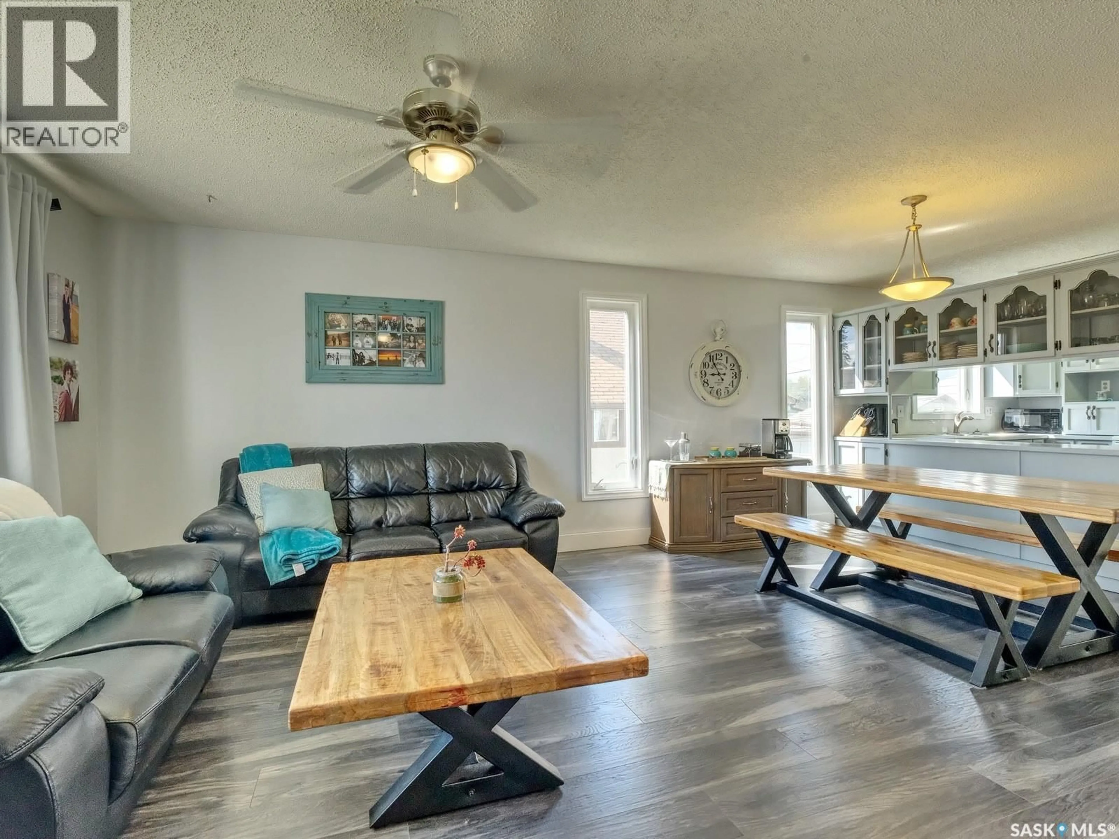 Living room with furniture, wood/laminate floor for 311 4TH AVENUE, Biggar Saskatchewan S0K0M0