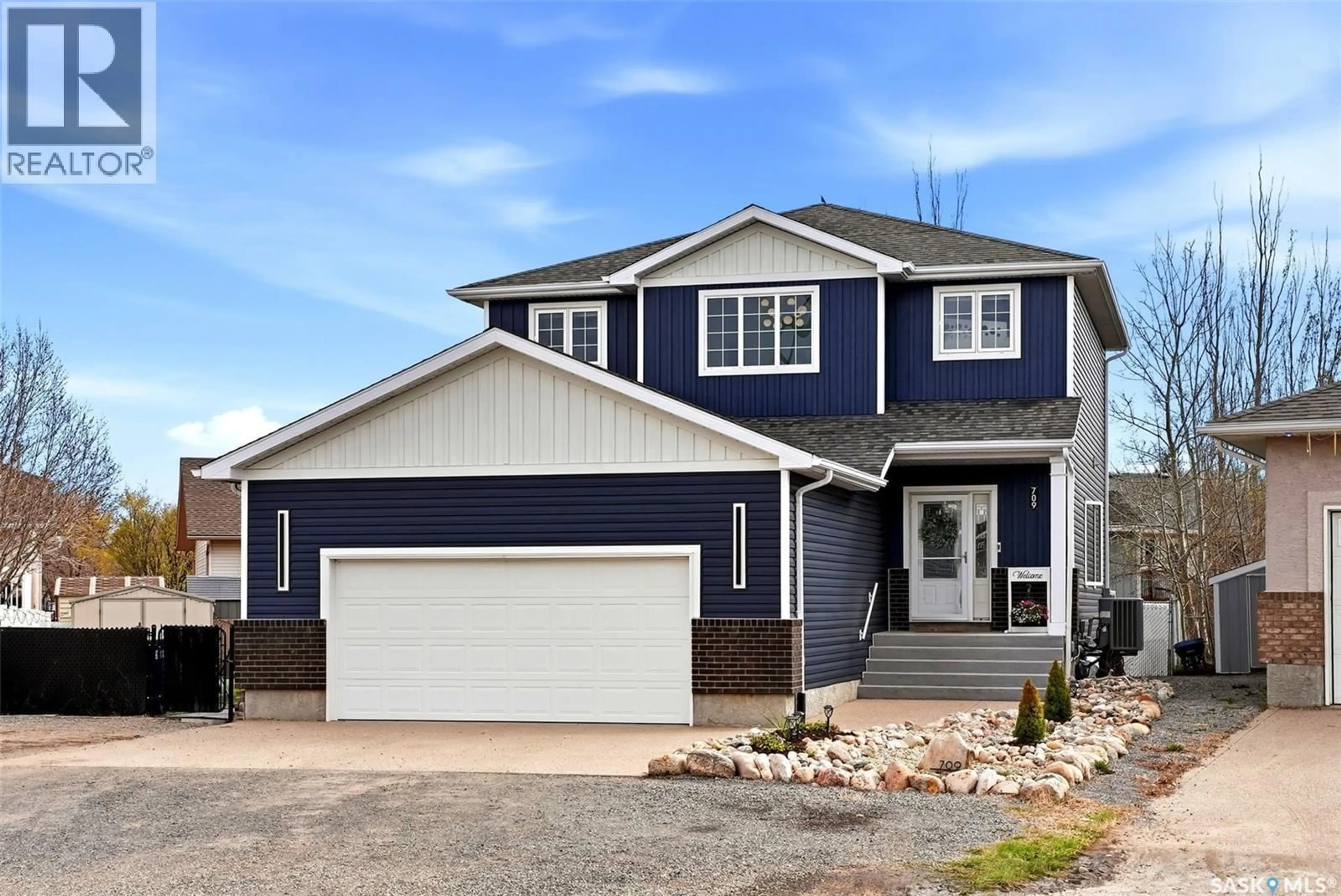 Home with vinyl exterior material, street for 709 ASPEN CRESCENT, Pilot Butte Saskatchewan S0G3Z0