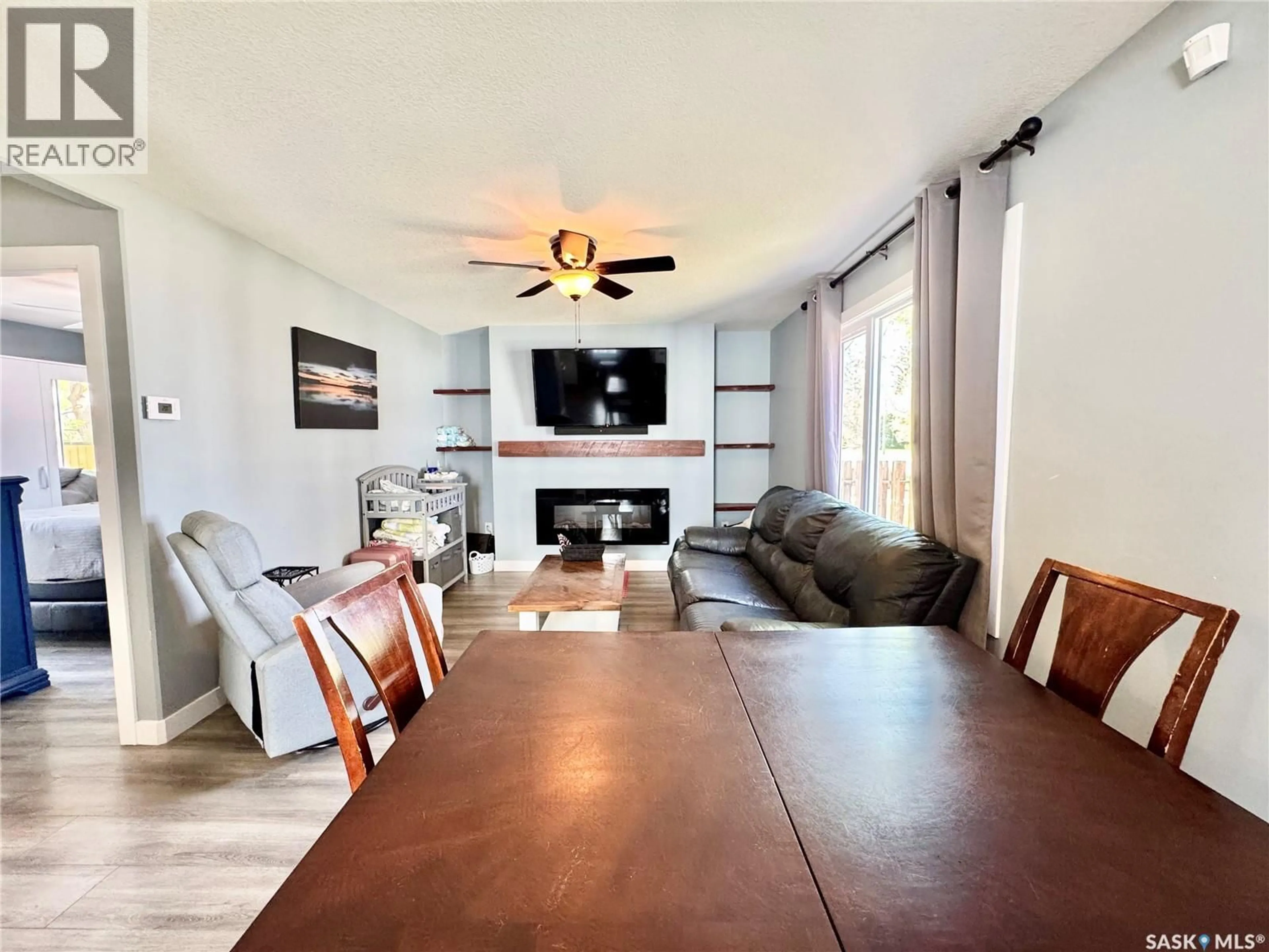 Living room with furniture, wood/laminate floor for 719 4TH STREET, Prince Albert Saskatchewan S6V0K4