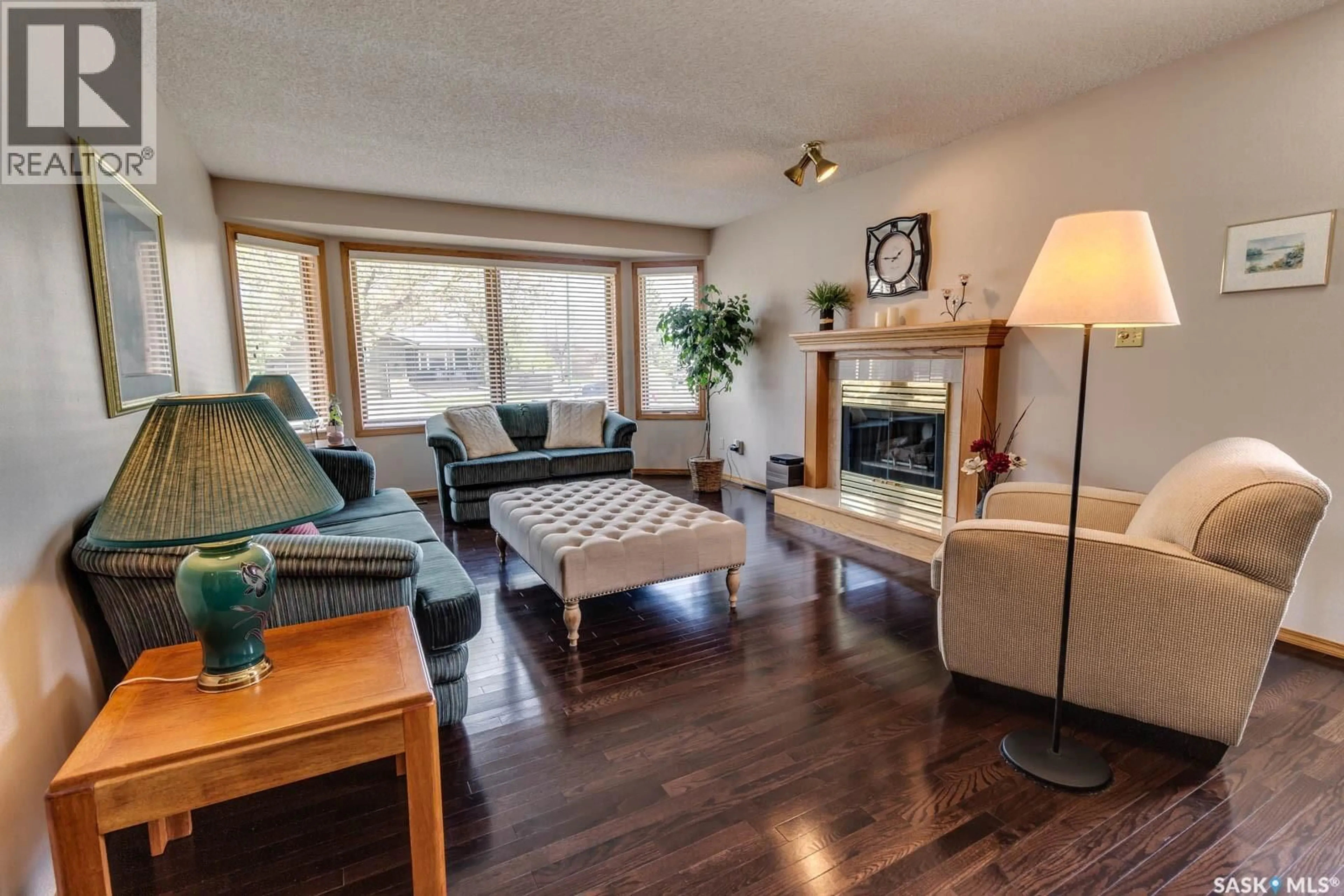 Living room with furniture, wood/laminate floor for 205 HECTOR CRESCENT, Regina Saskatchewan S4Y1C1