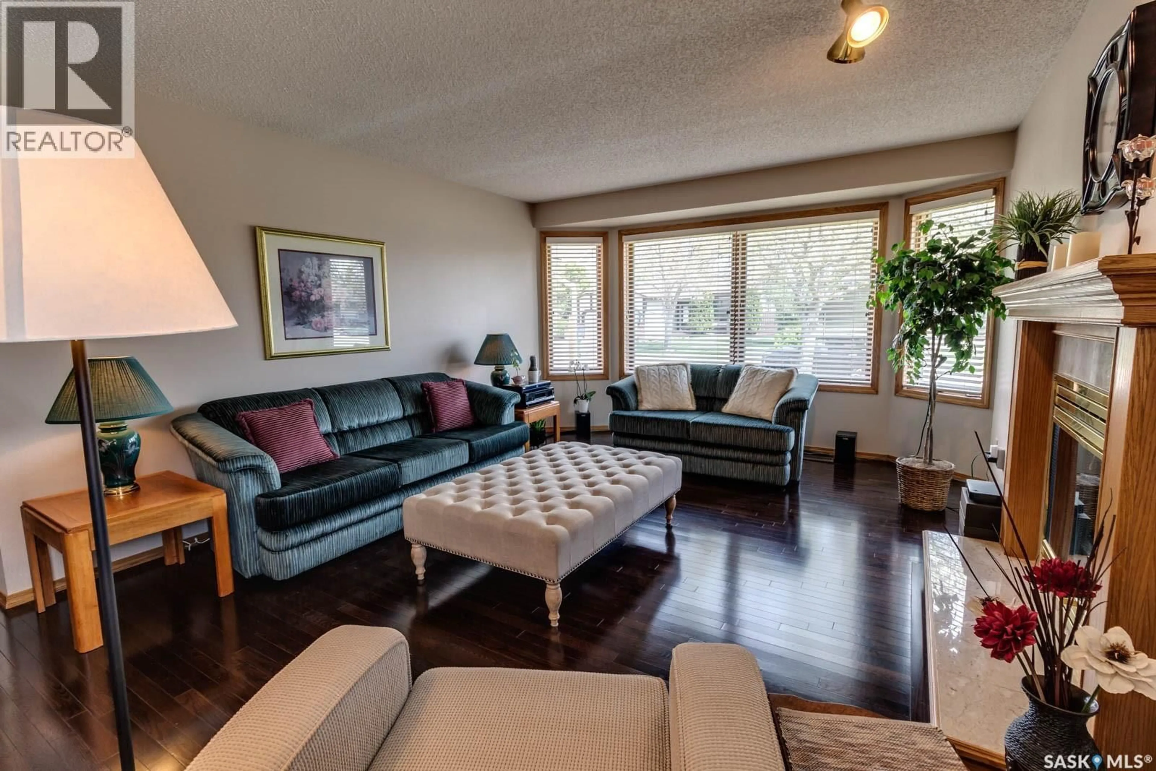 Living room with furniture, wood/laminate floor for 205 HECTOR CRESCENT, Regina Saskatchewan S4Y1C1