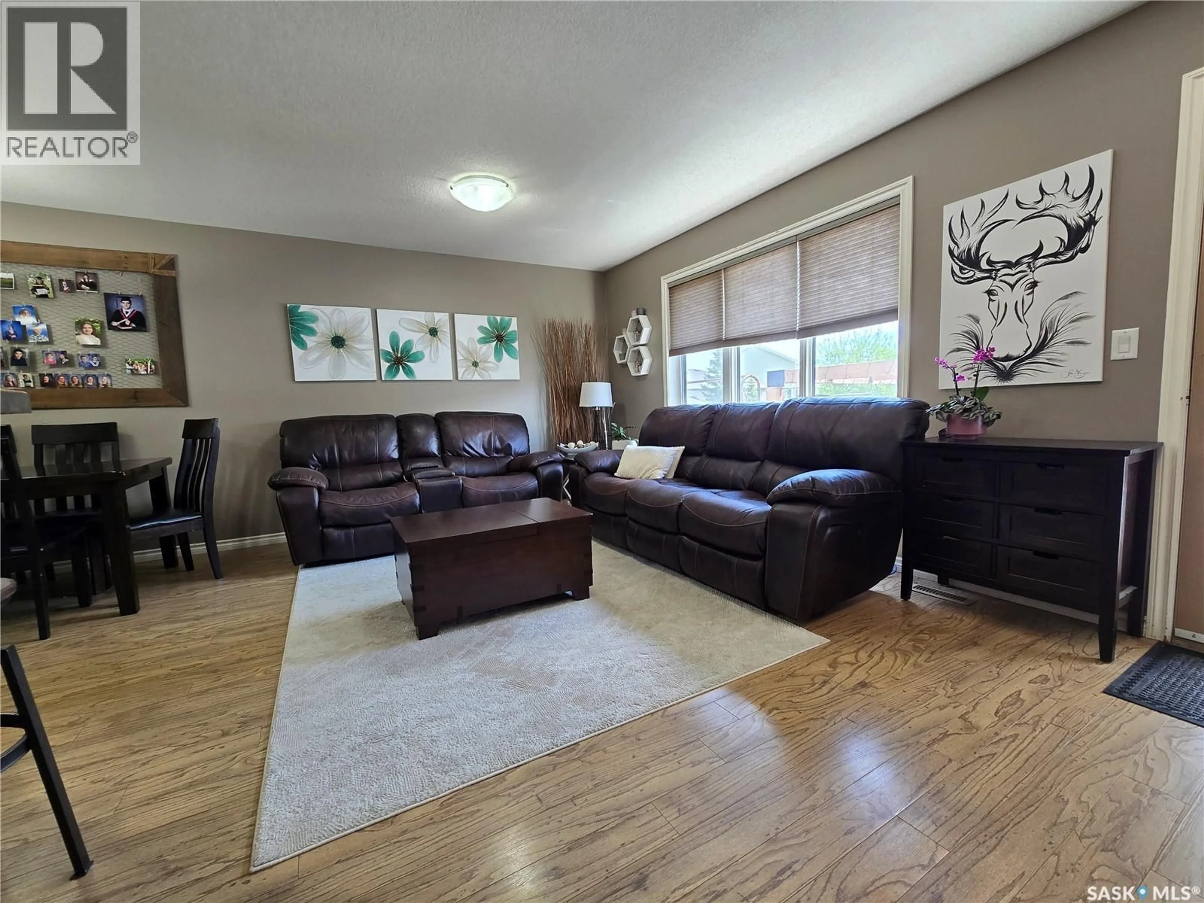 Living room with furniture, wood/laminate floor for 610 BARBER CRESCENT, Weyburn Saskatchewan S4H0M9