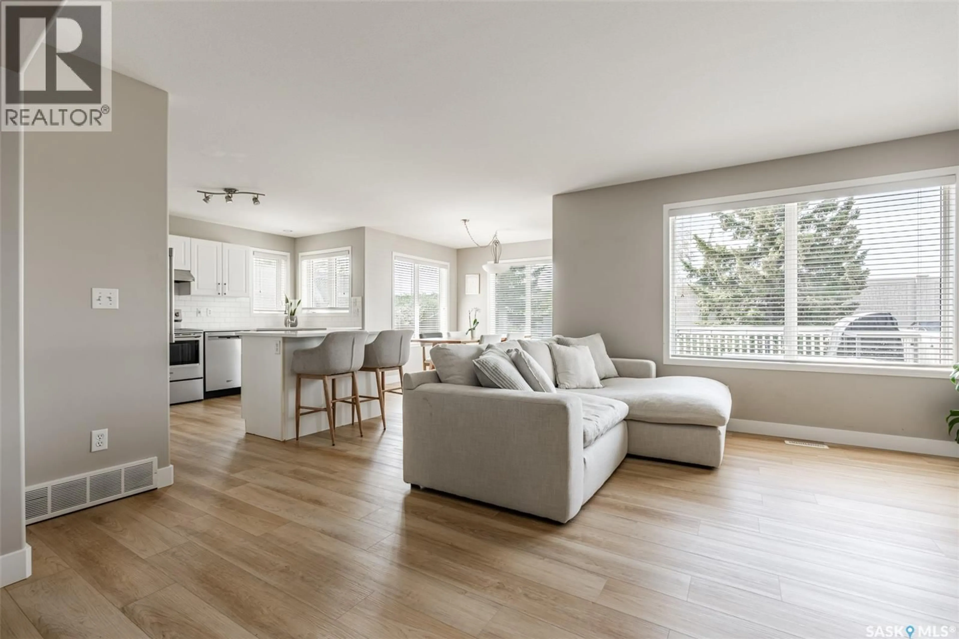 Living room with furniture, wood/laminate floor for 451 BUCKWOLD COVE, Saskatoon Saskatchewan S7N4W1
