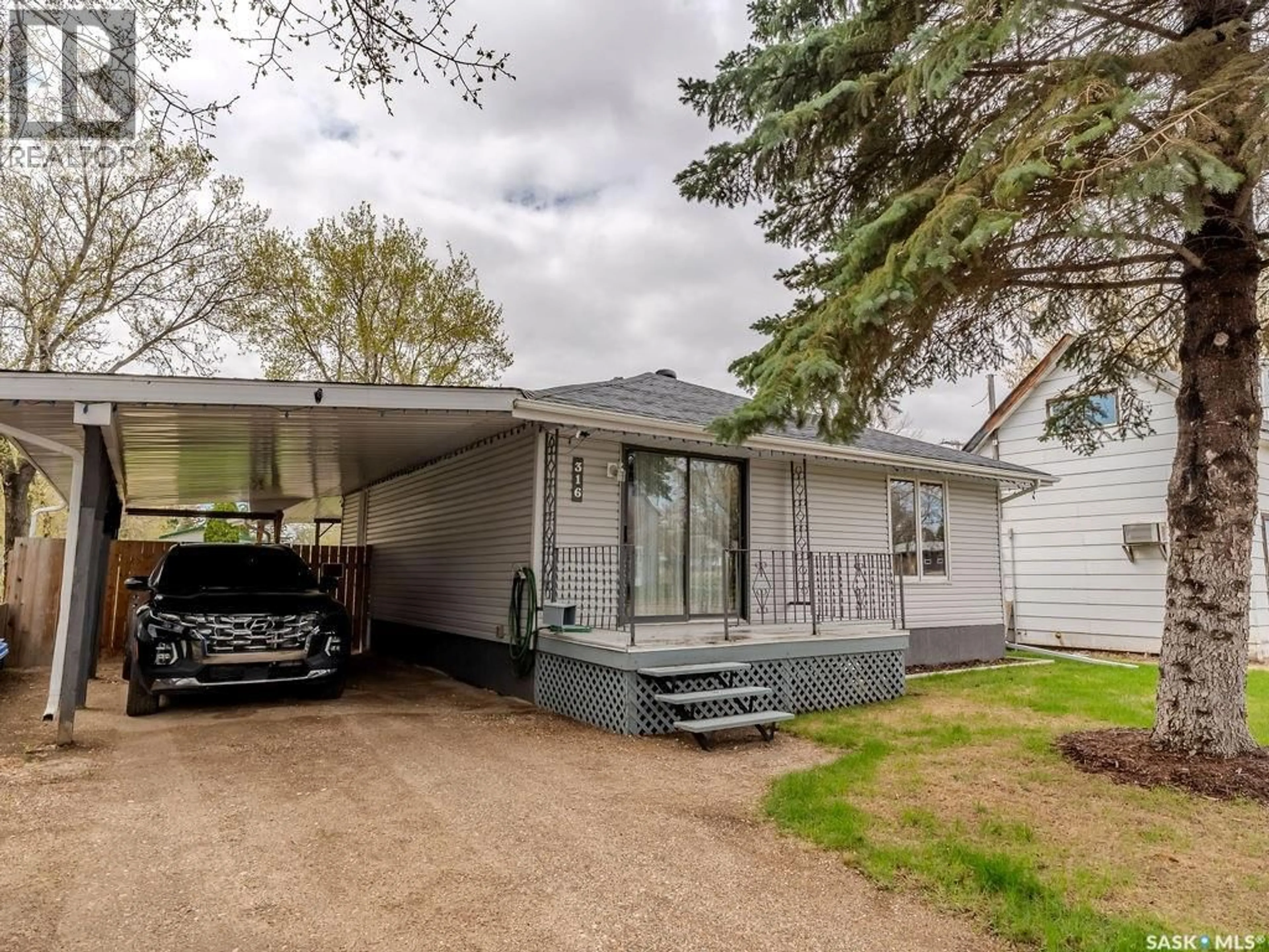 Home with vinyl exterior material, street for 316 1ST STREET, Delisle Saskatchewan S0L0P0