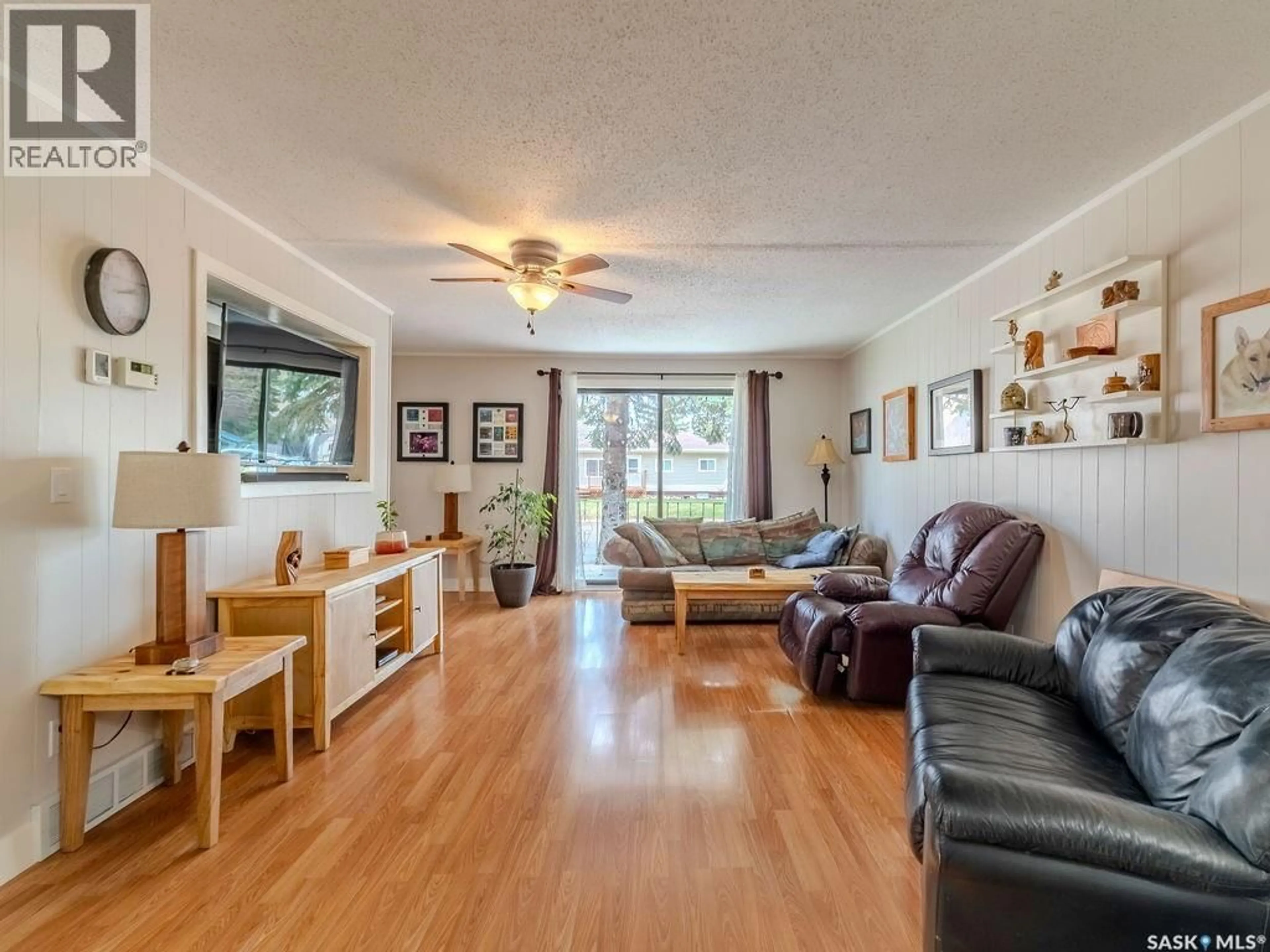 Living room with furniture, wood/laminate floor for 316 1ST STREET, Delisle Saskatchewan S0L0P0