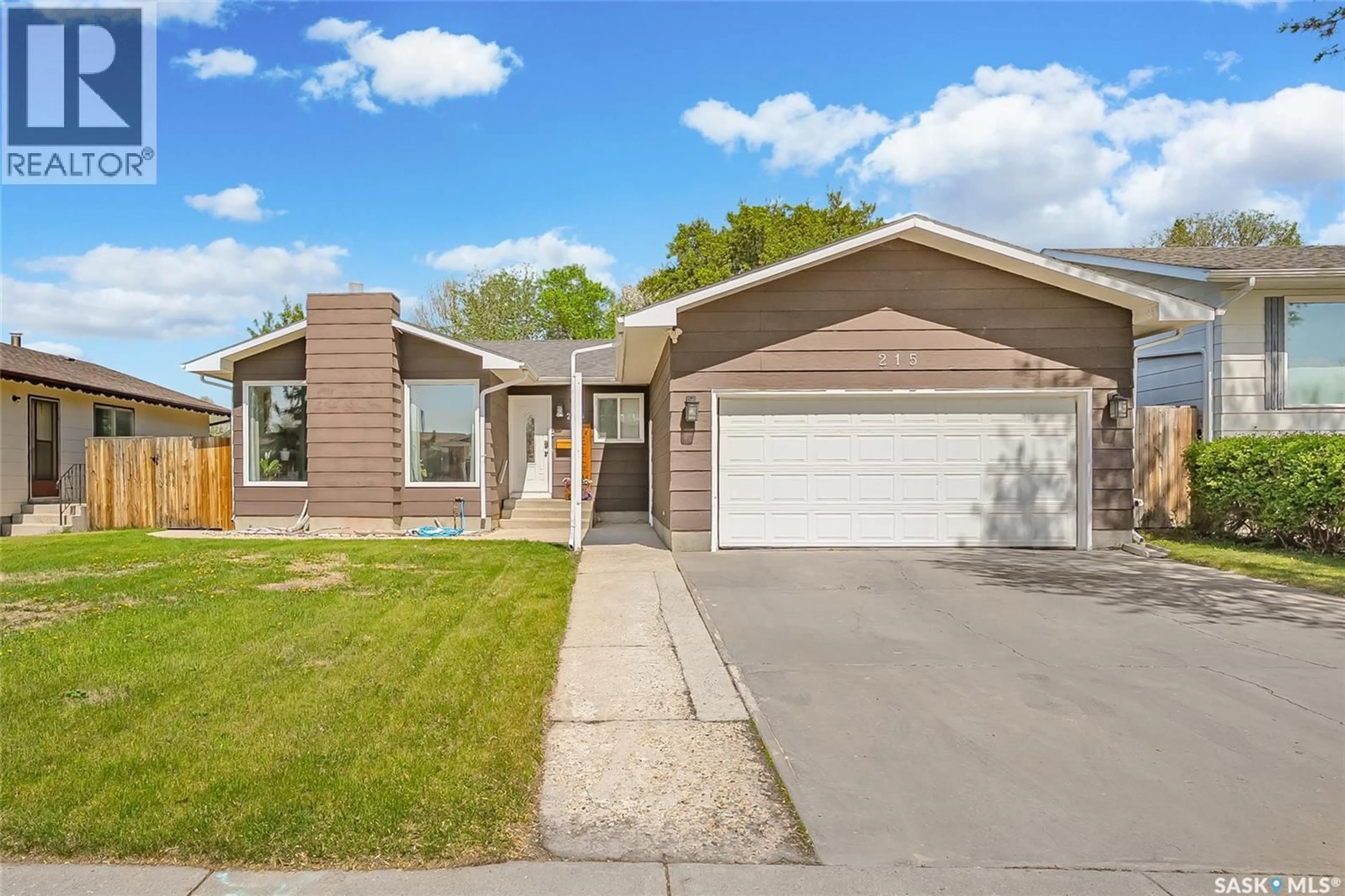 Home with vinyl exterior material, street for 215 NEATBY CRESCENT, Saskatoon Saskatchewan S7M4W9