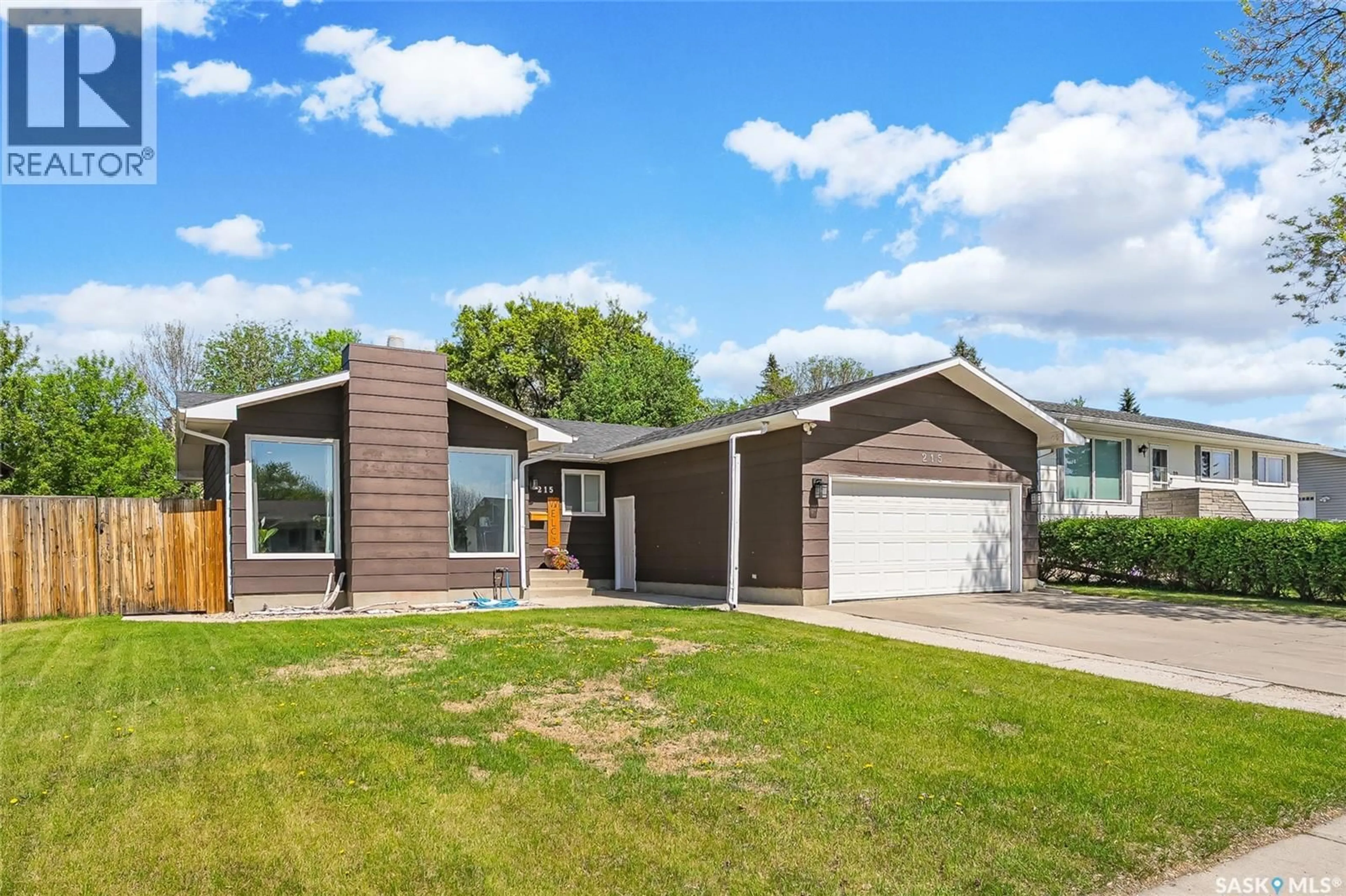 Home with vinyl exterior material, street for 215 NEATBY CRESCENT, Saskatoon Saskatchewan S7M4W9