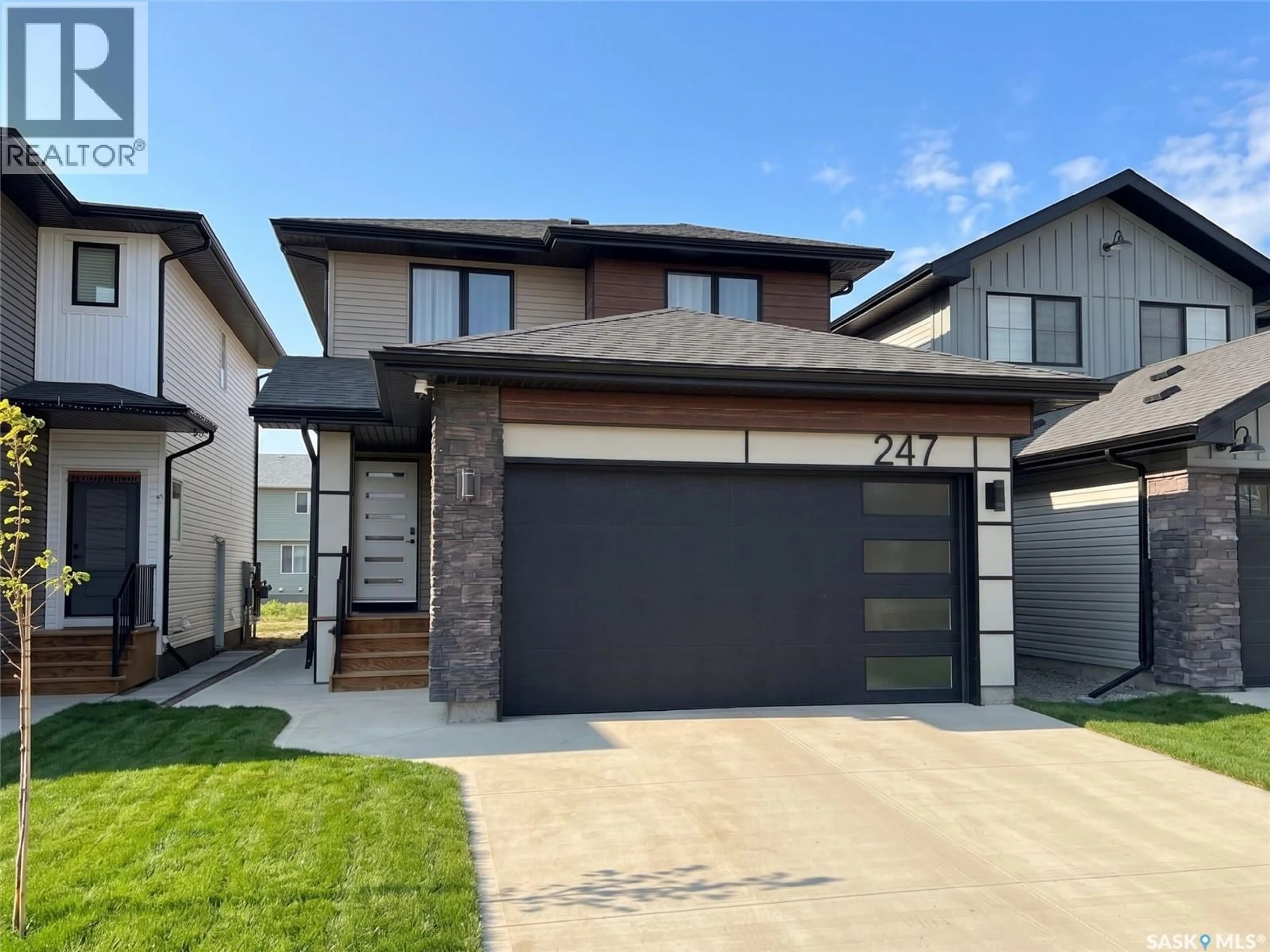 Home with brick exterior material, street for 247 ASOKAN STREET, Saskatoon Saskatchewan S7V1V7