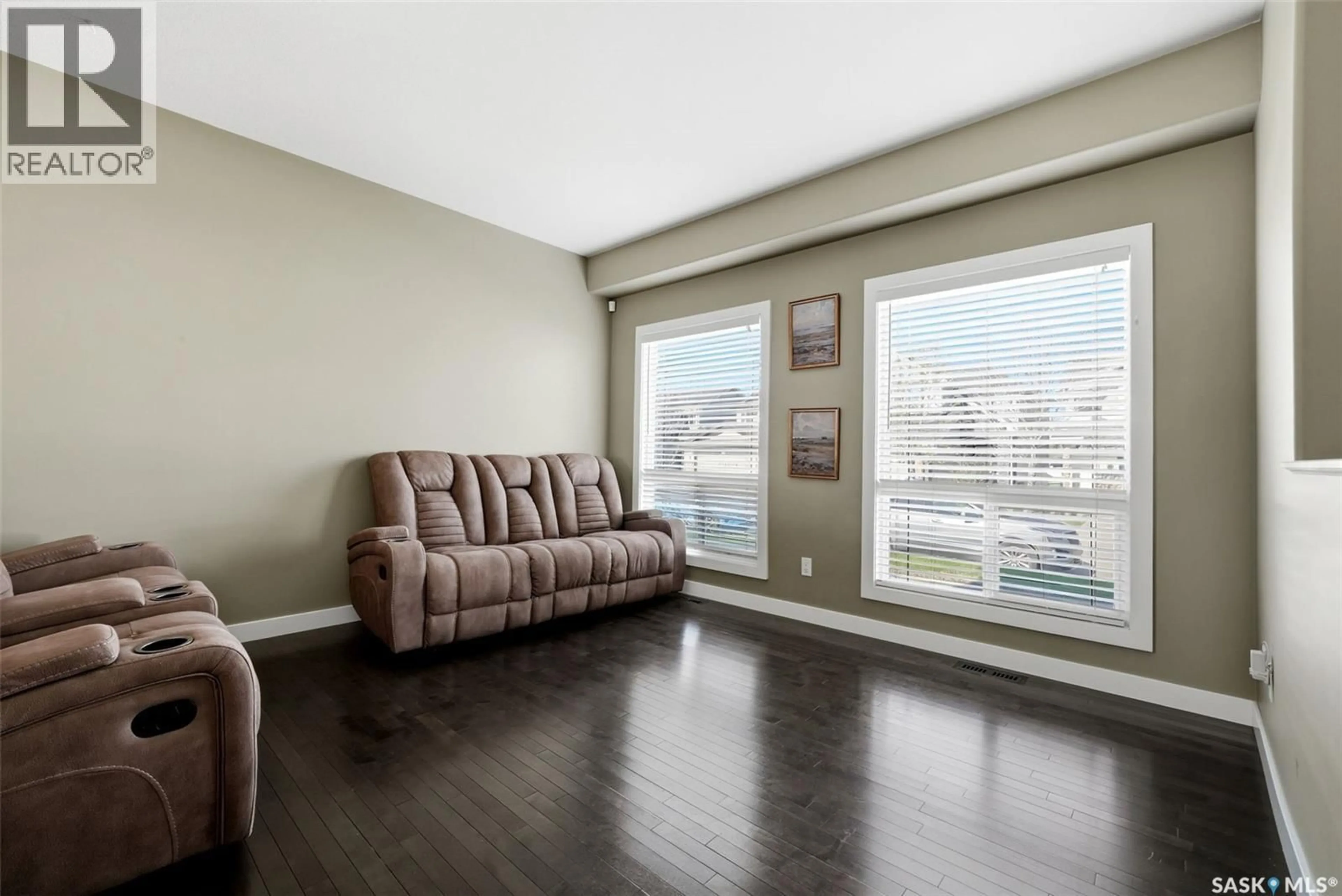 Living room with furniture, wood/laminate floor for 3354 GREEN MOSS LANE, Regina Saskatchewan S4V1P2