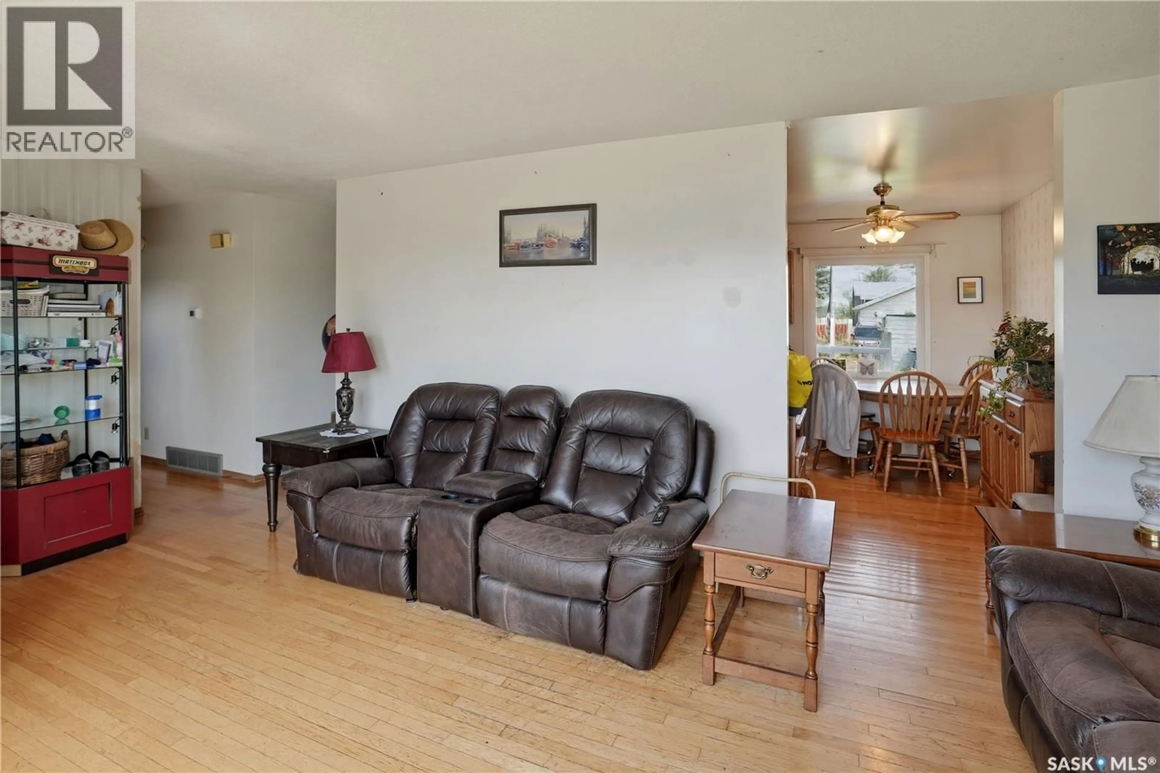 Living room with furniture, wood/laminate floor for 2106 101ST CRESCENT, North Battleford Saskatchewan S9A1C3