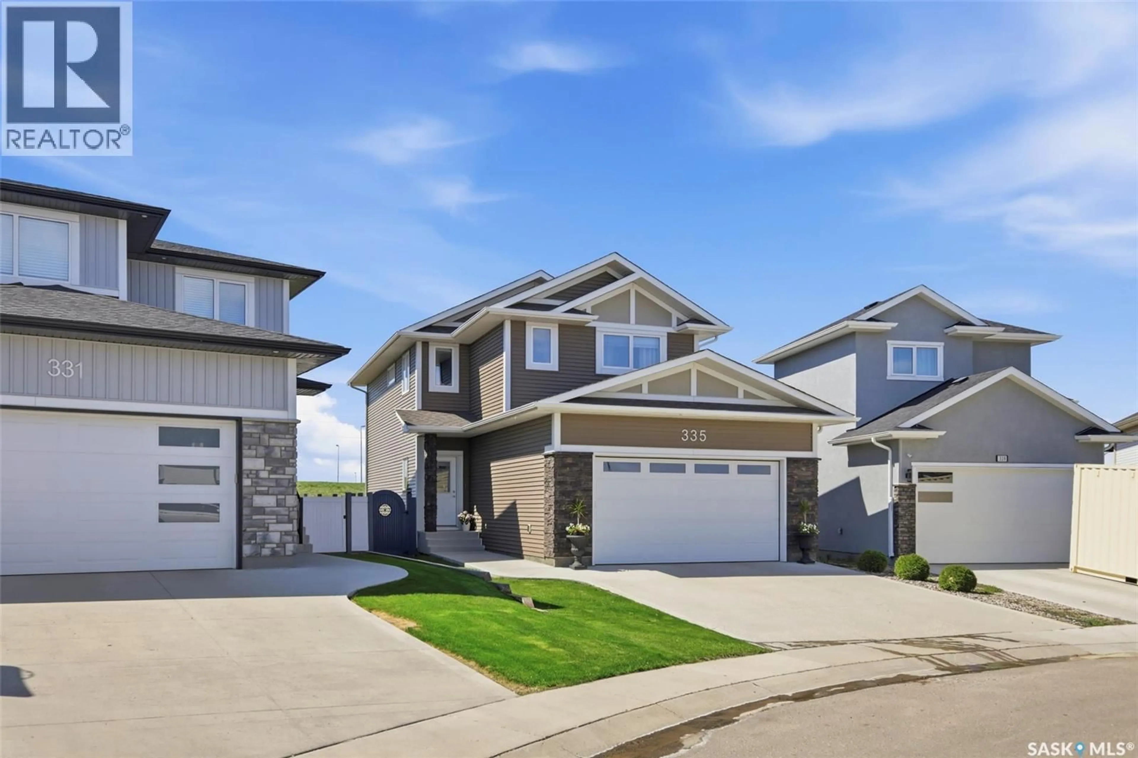 Home with vinyl exterior material, street for 335 HASSARD CLOSE, Saskatoon Saskatchewan S7L4Y7
