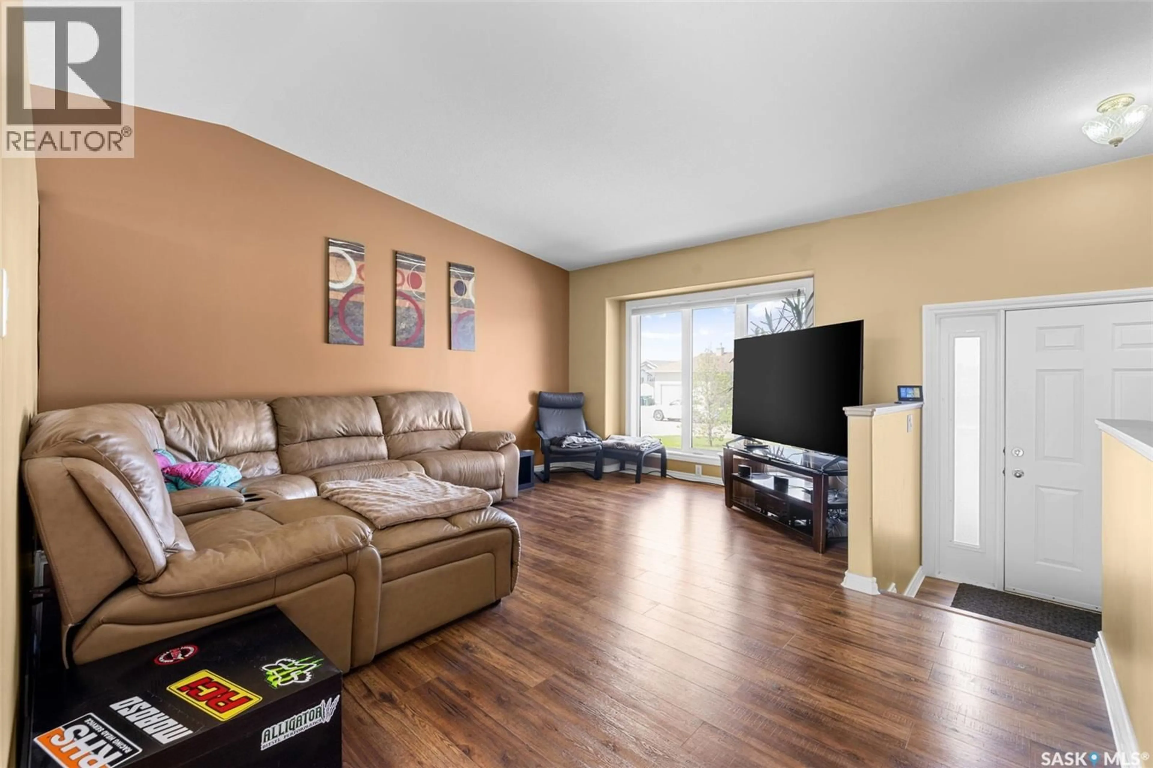 Living room with furniture, wood/laminate floor for 413 HAWKES STREET, Balgonie Saskatchewan S0G0E0