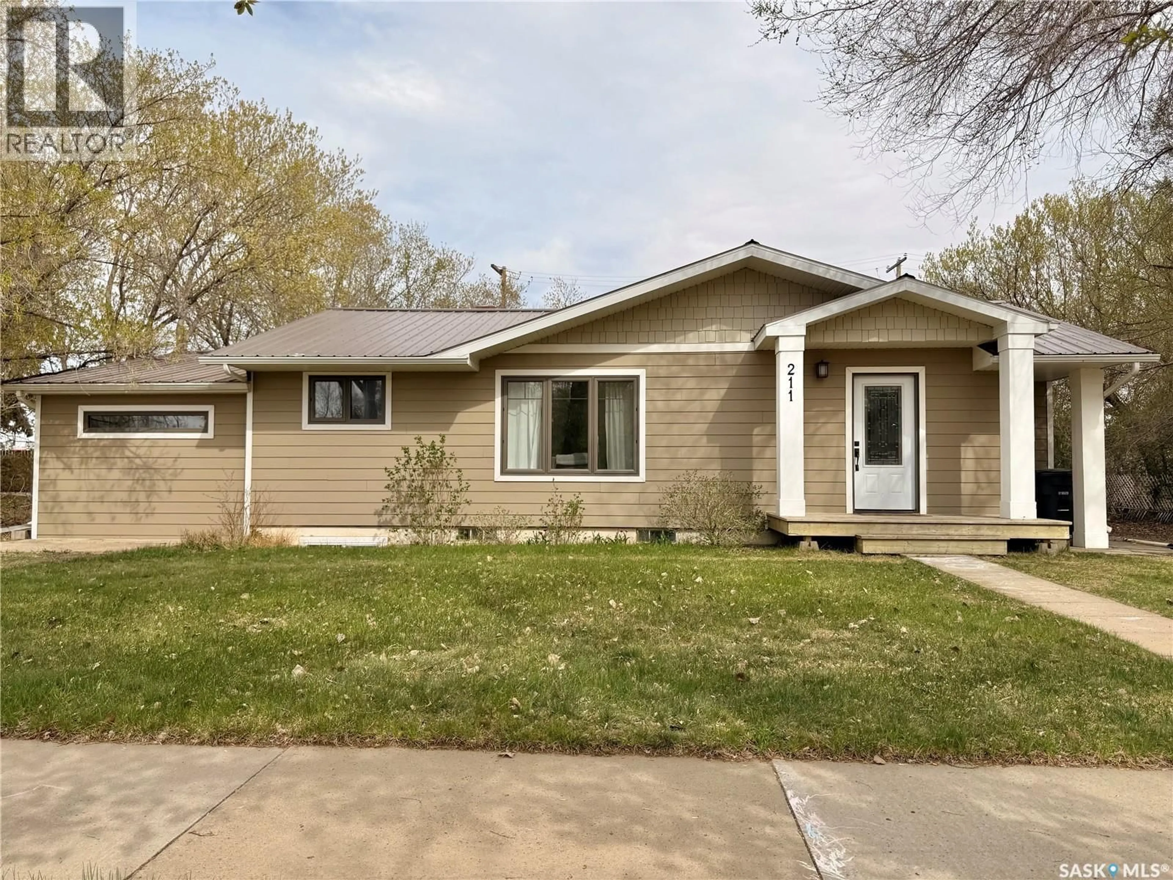 Home with vinyl exterior material, street for 211 PANGMAN STREET, Outlook Saskatchewan S0L2N0