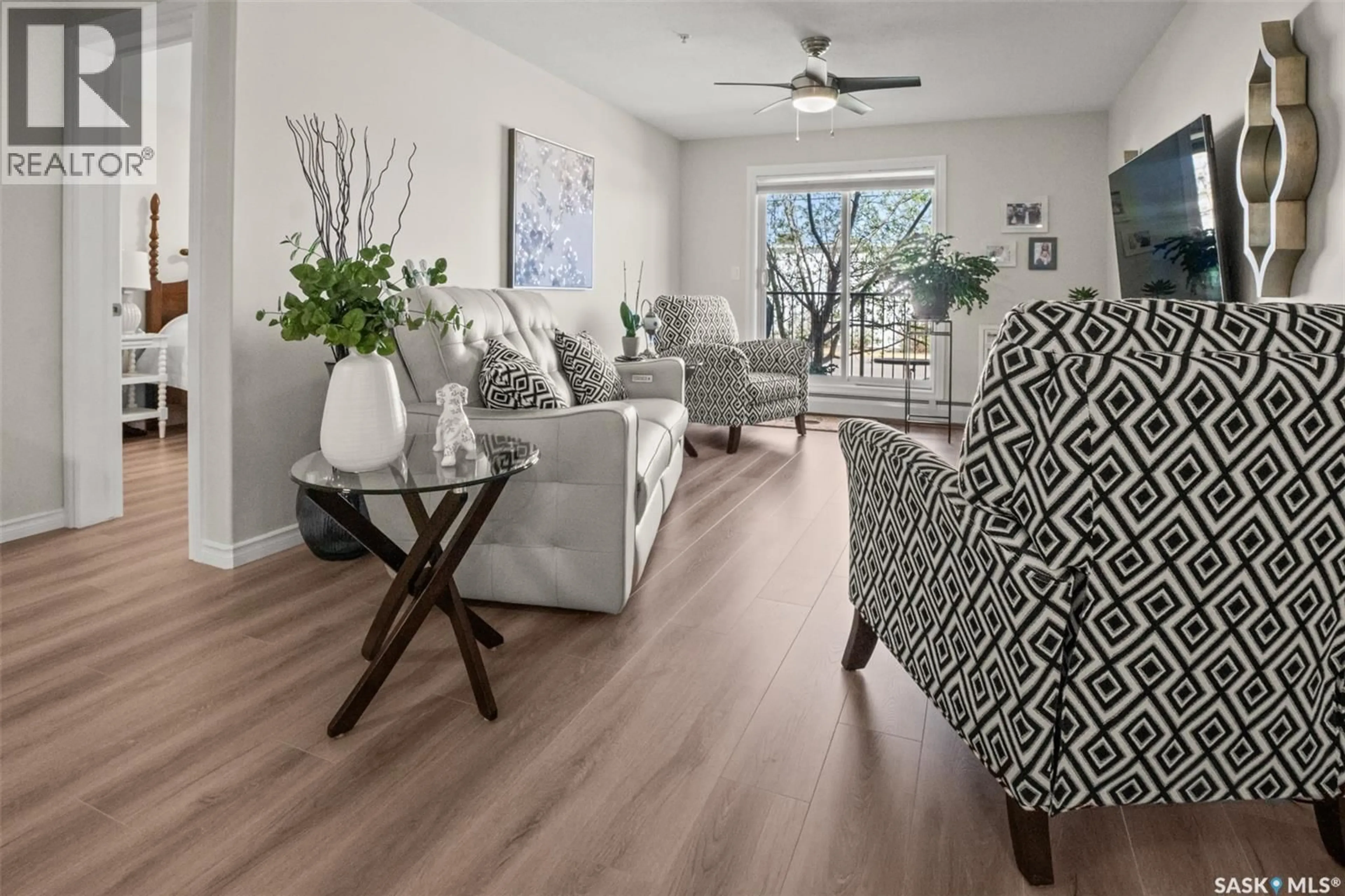 Living room with furniture, wood/laminate floor for 100 - 105 1ST AVENUE, Warman Saskatchewan S0K0A1