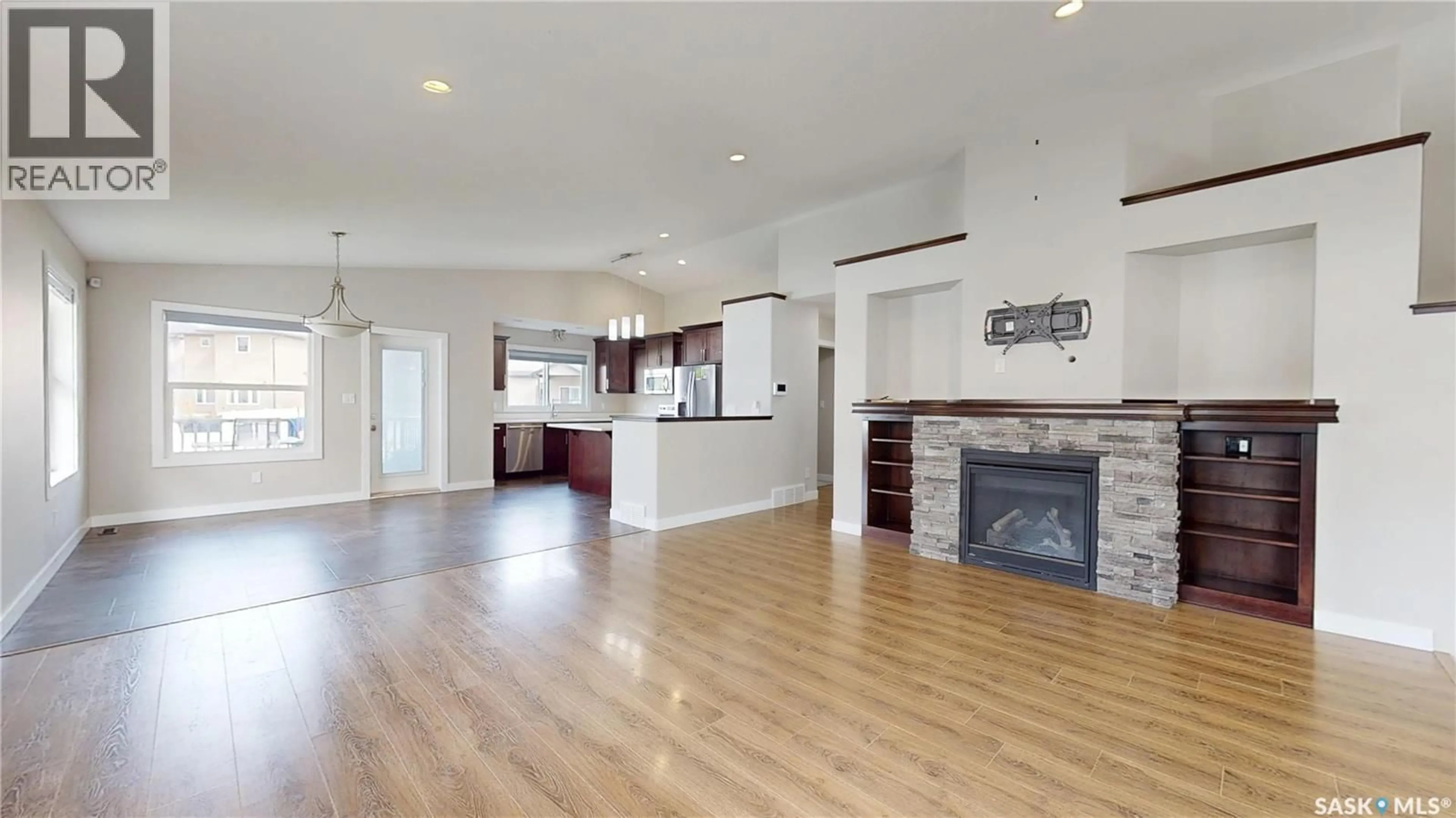 Open concept kitchen, wood/laminate floor for 5614 BEACON PLACE, Regina Saskatchewan S4W0J7