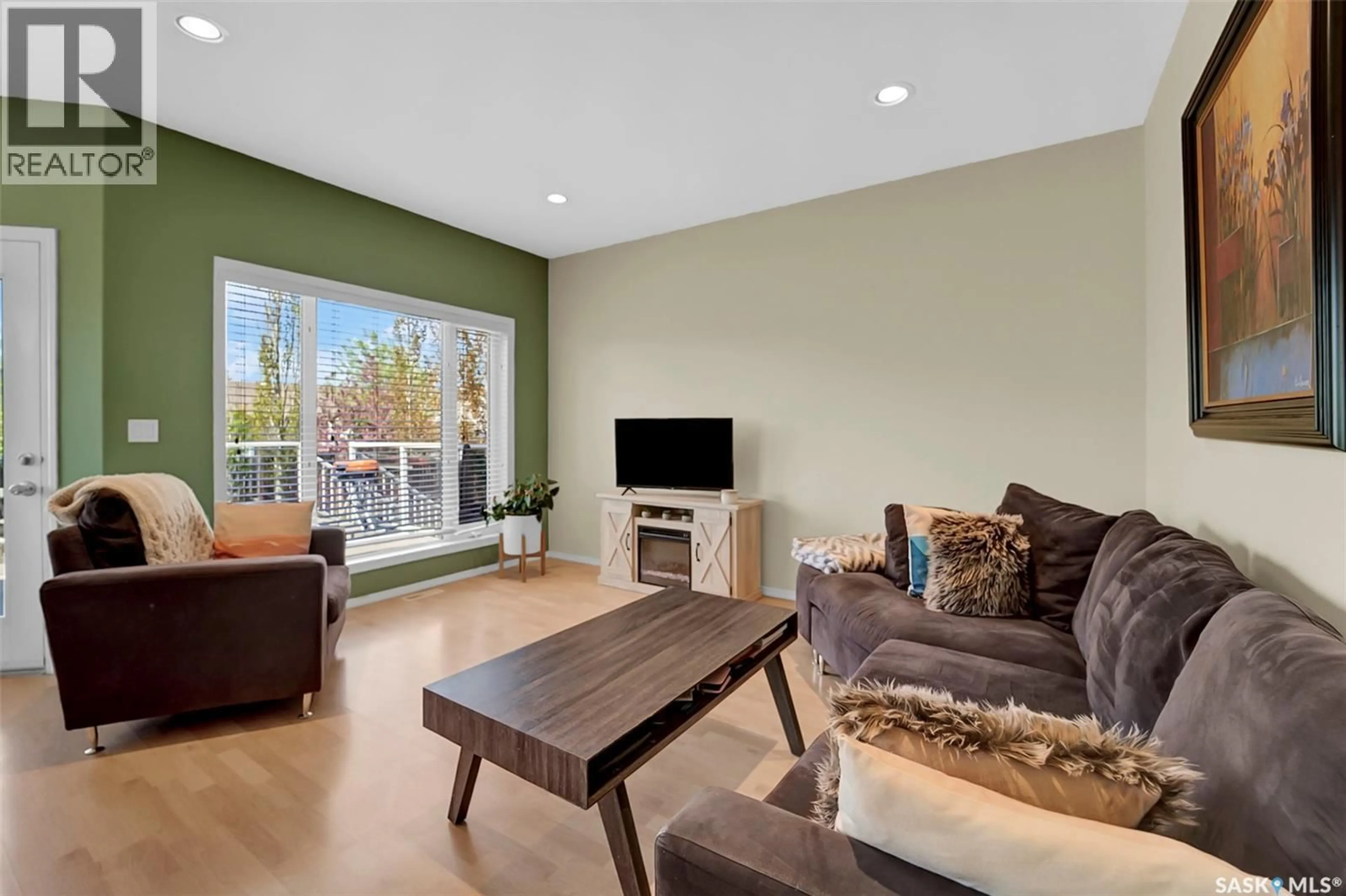 Living room with furniture, wood/laminate floor for 729 GRABOWSKI CRESCENT, Warman Saskatchewan S0K4S0