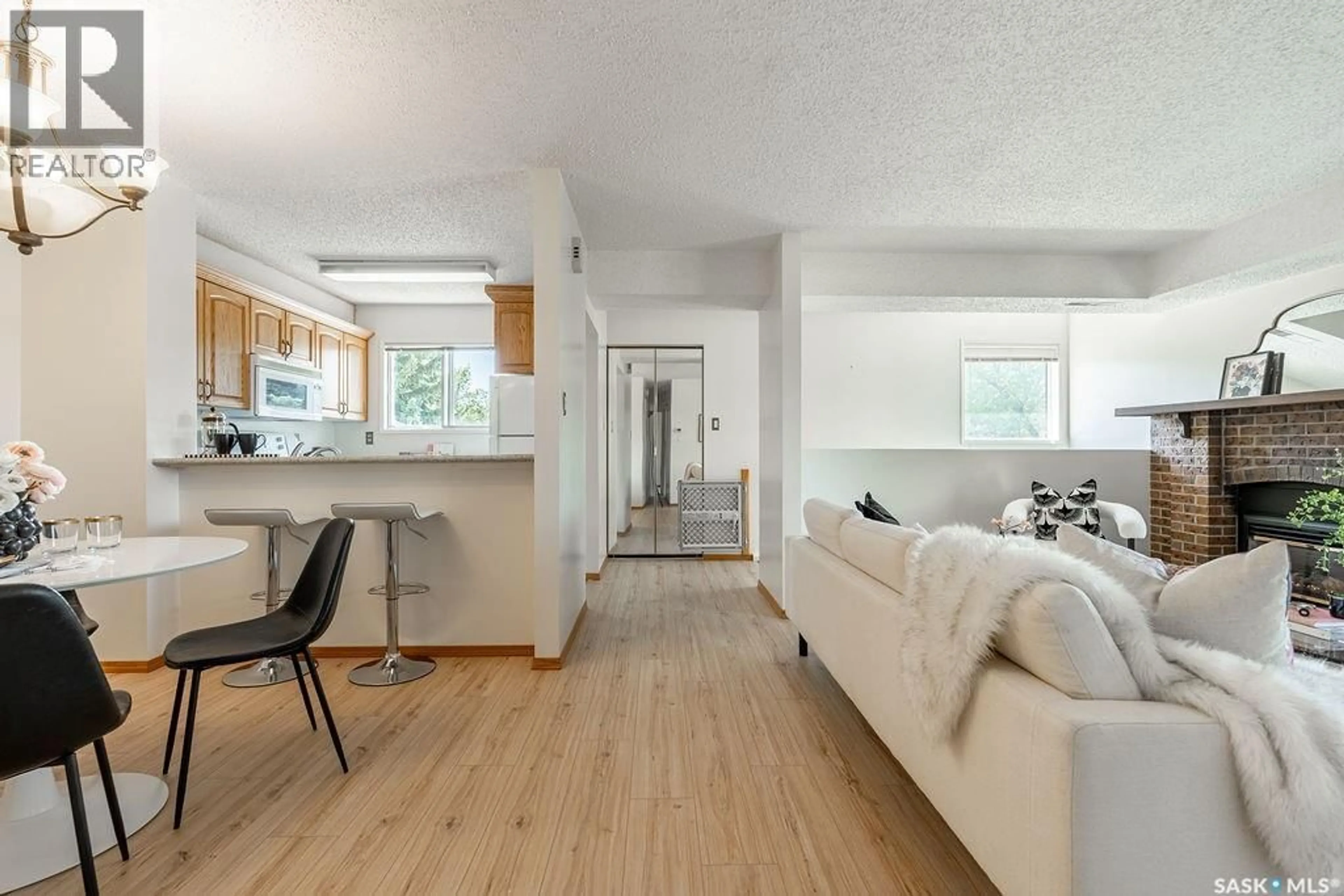 Living room with furniture, wood/laminate floor for 603 - 507 LENORE DRIVE, Saskatoon Saskatchewan S7K6S1