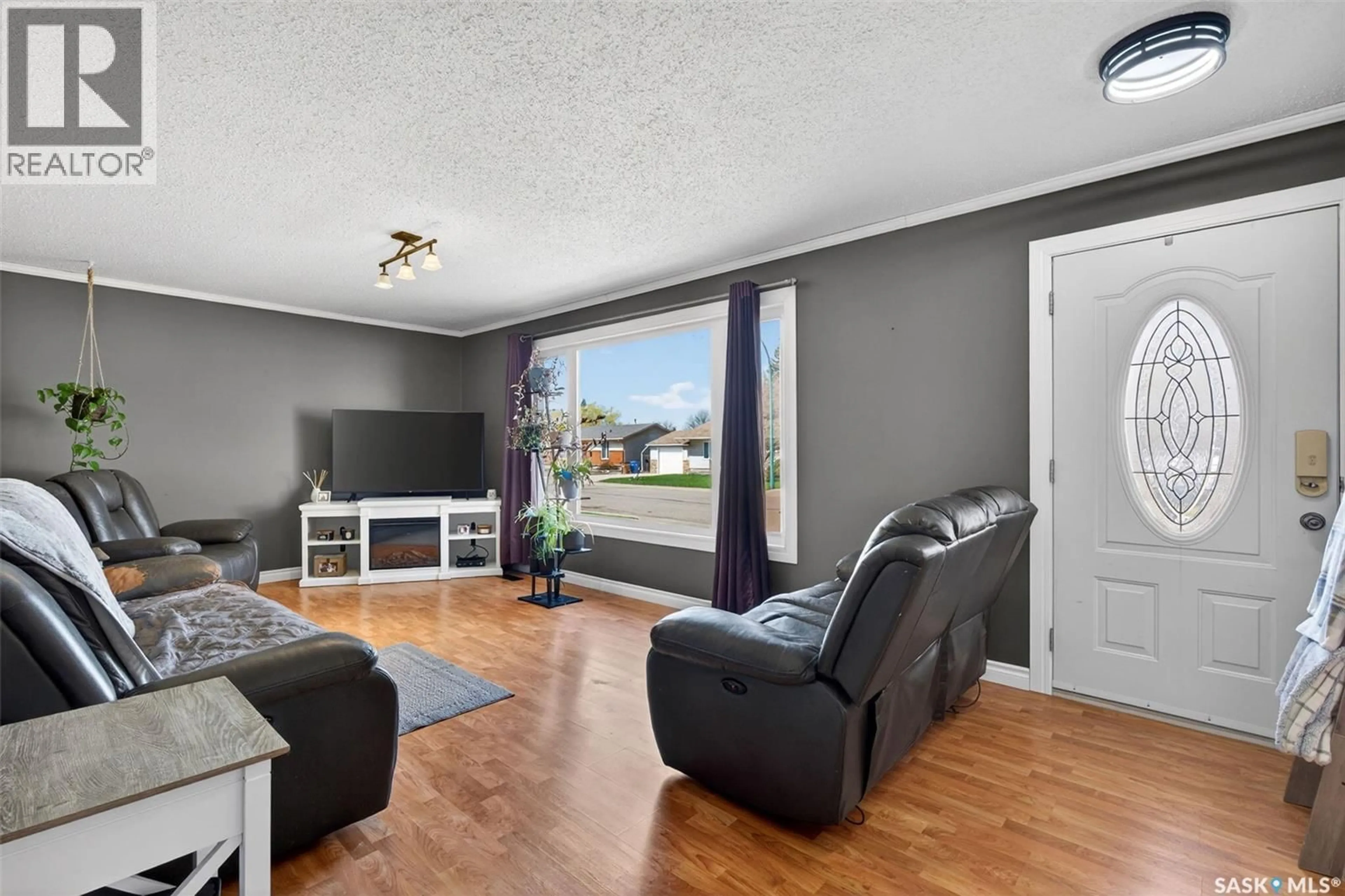 Living room with furniture, wood/laminate floor for 314 CASKEY DRIVE, Melfort Saskatchewan S0E1A0