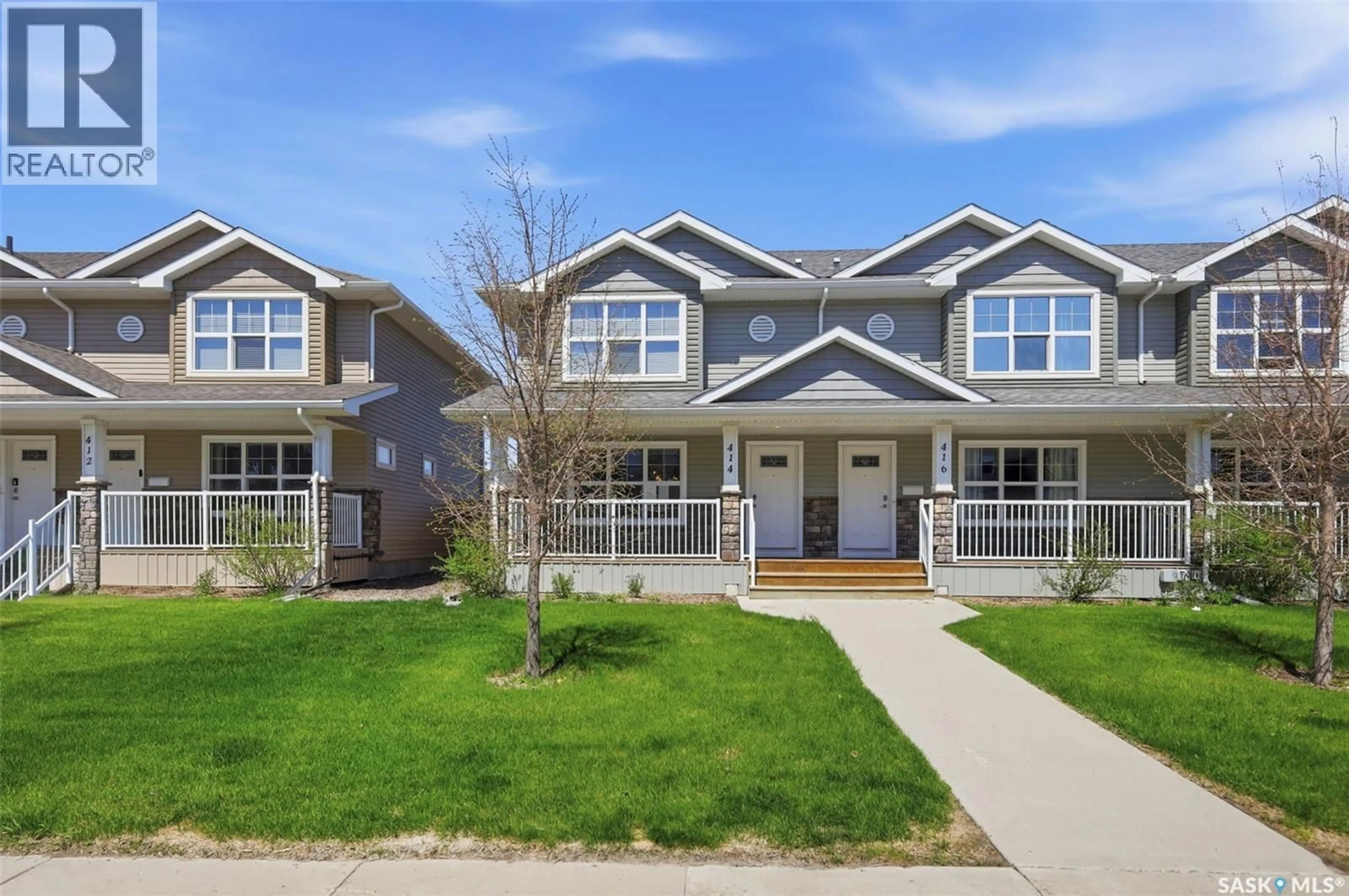 Home with vinyl exterior material, street for 414 MANINGAS BEND, Saskatoon Saskatchewan S7W0V6