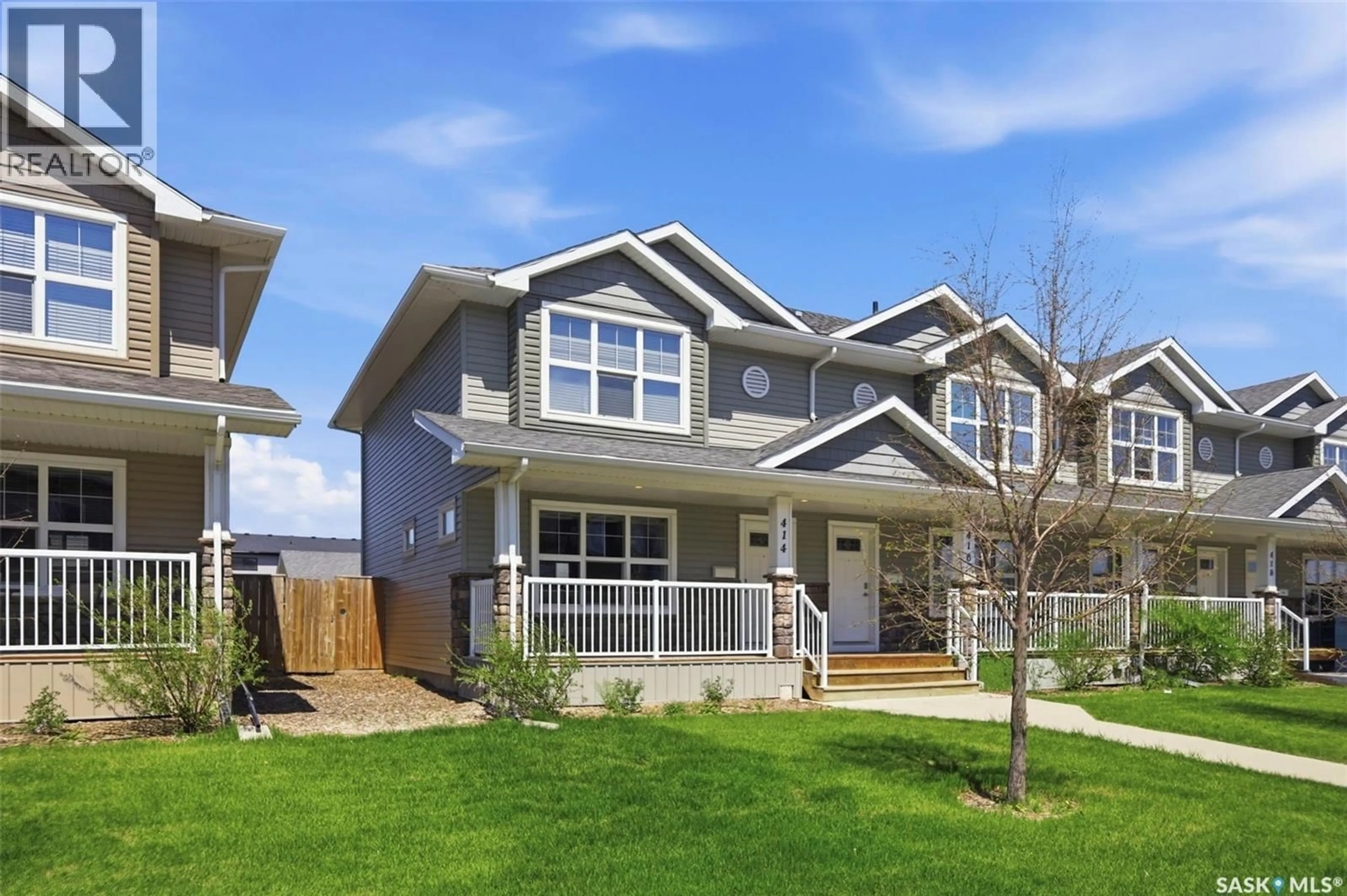 Home with vinyl exterior material, street for 414 MANINGAS BEND, Saskatoon Saskatchewan S7W0V6