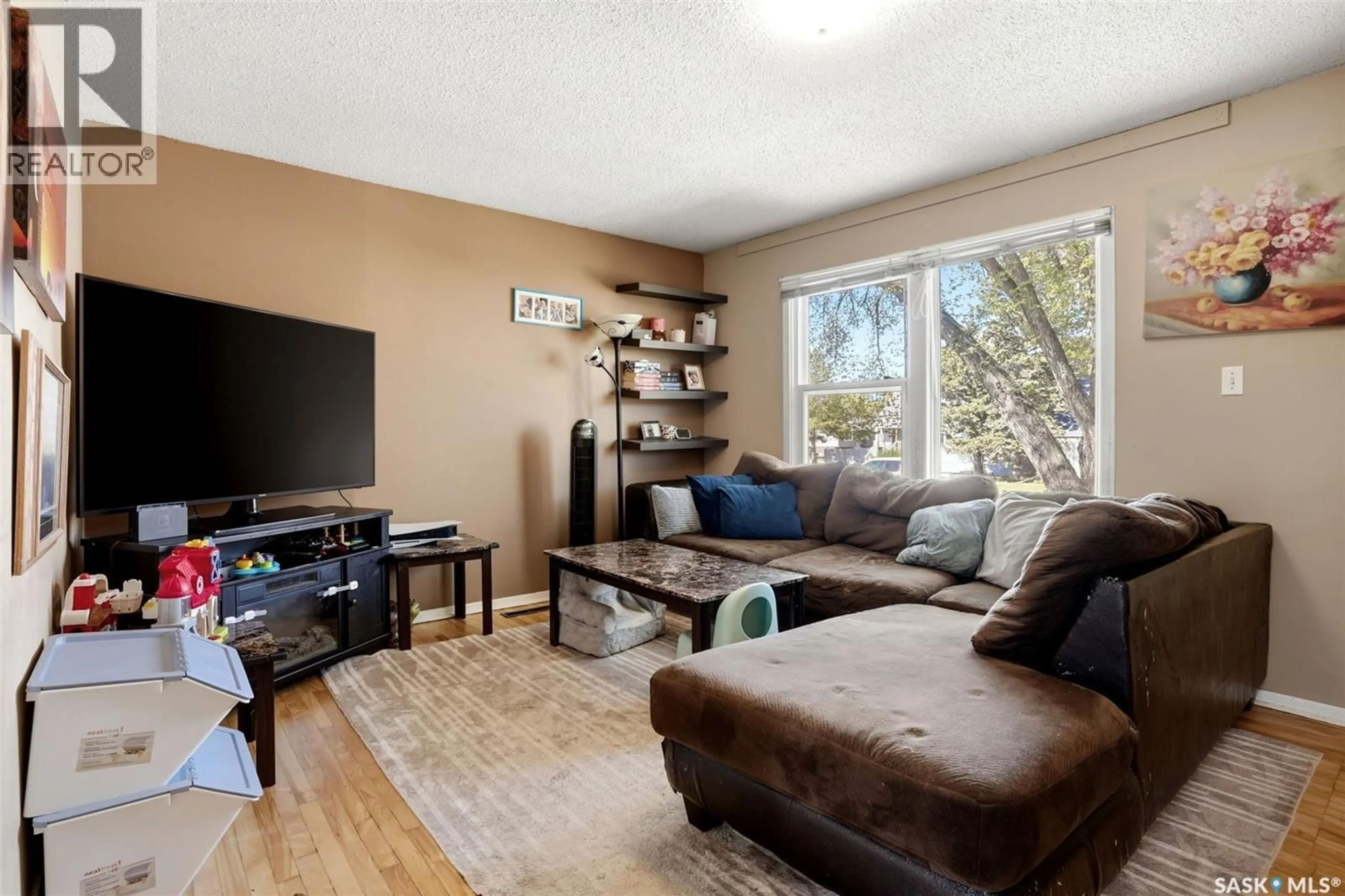 Living room with furniture, wood/laminate floor for 1763 ROYAL STREET, Regina Saskatchewan S4T5A8