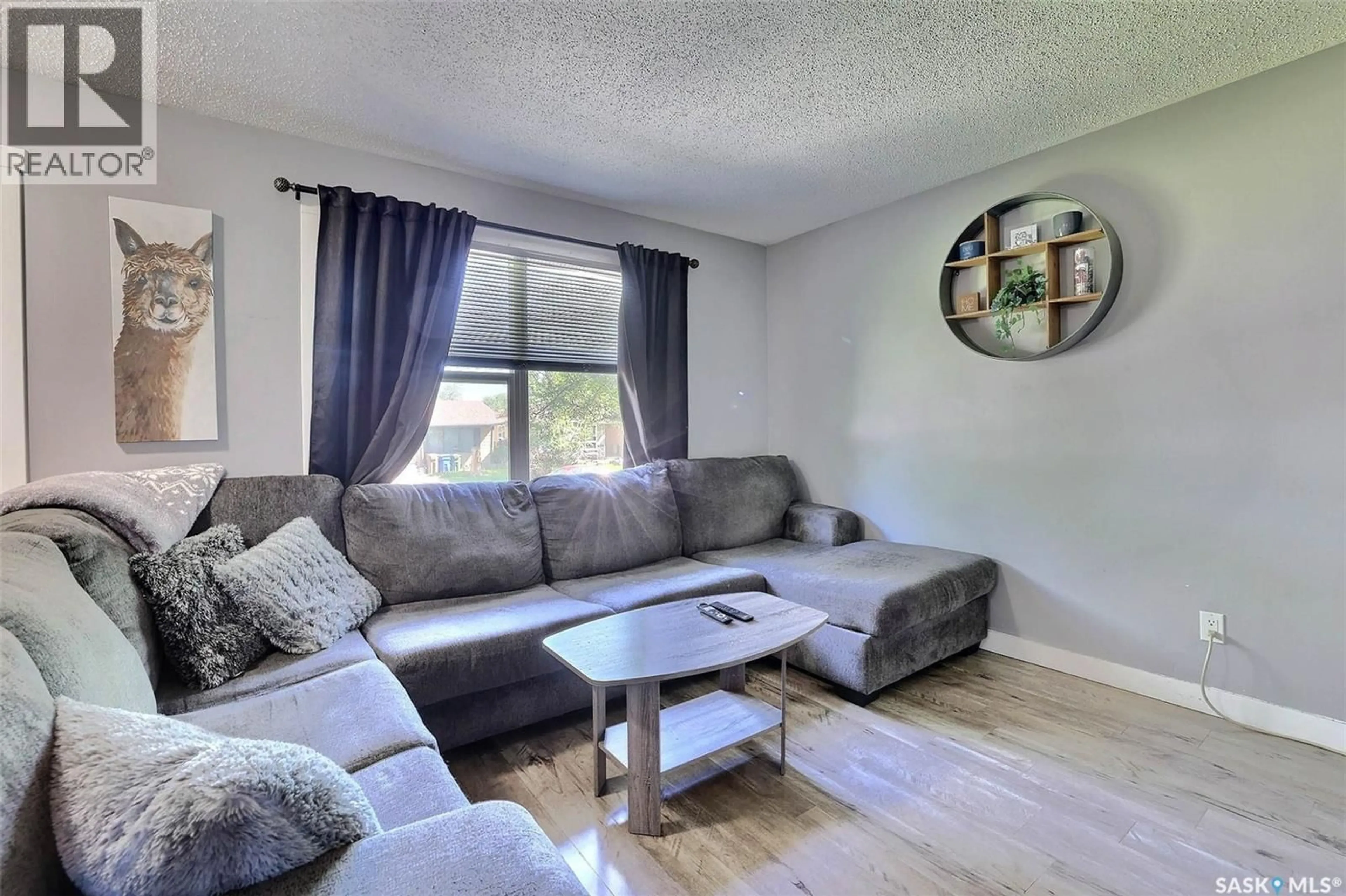 Living room with furniture, wood/laminate floor for 31 PAYNTER CRESCENT, Regina Saskatchewan S4X1H5