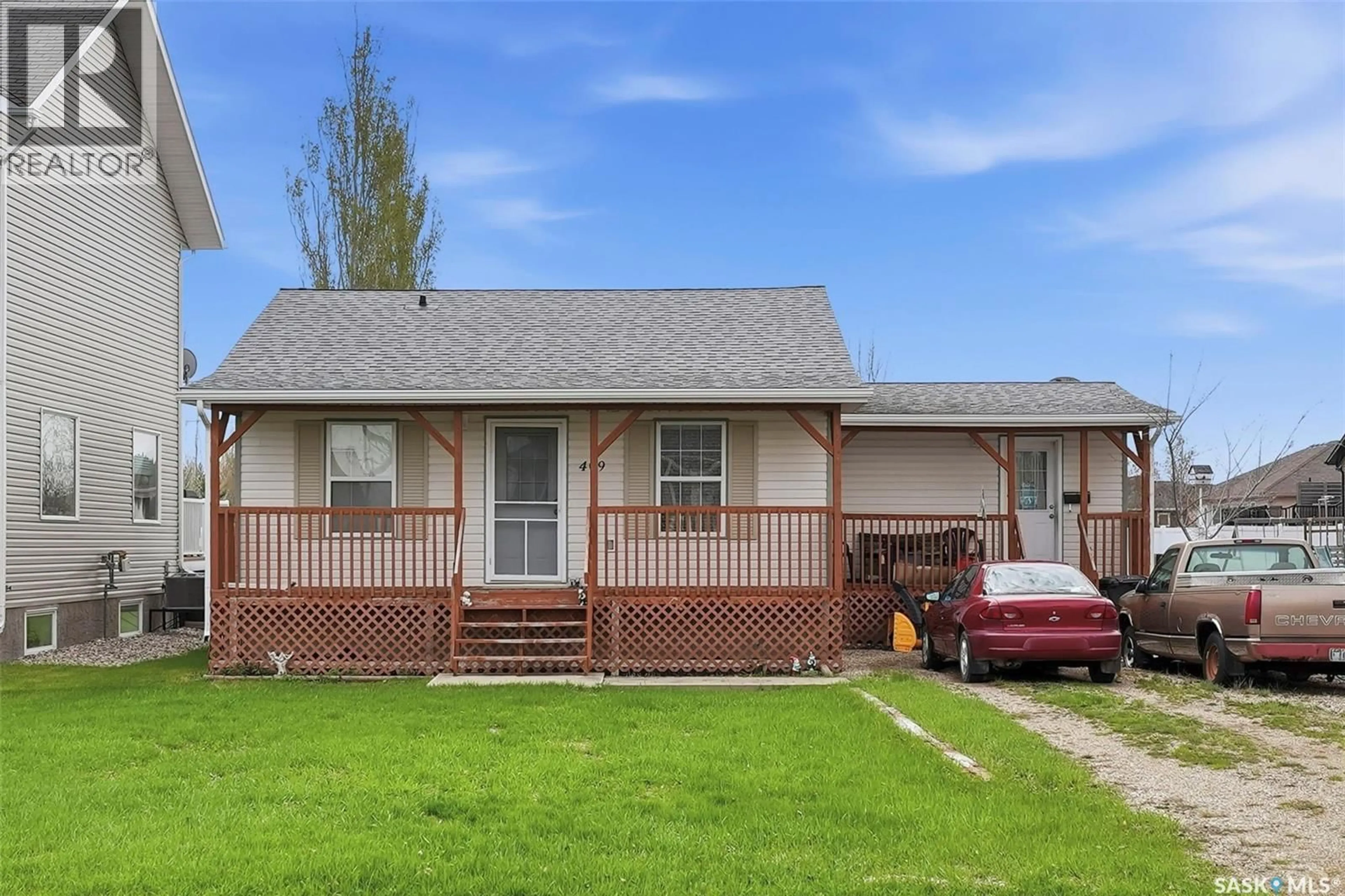 Home with vinyl exterior material, street for 409 8TH AVENUE, Watrous Saskatchewan S0K4T0